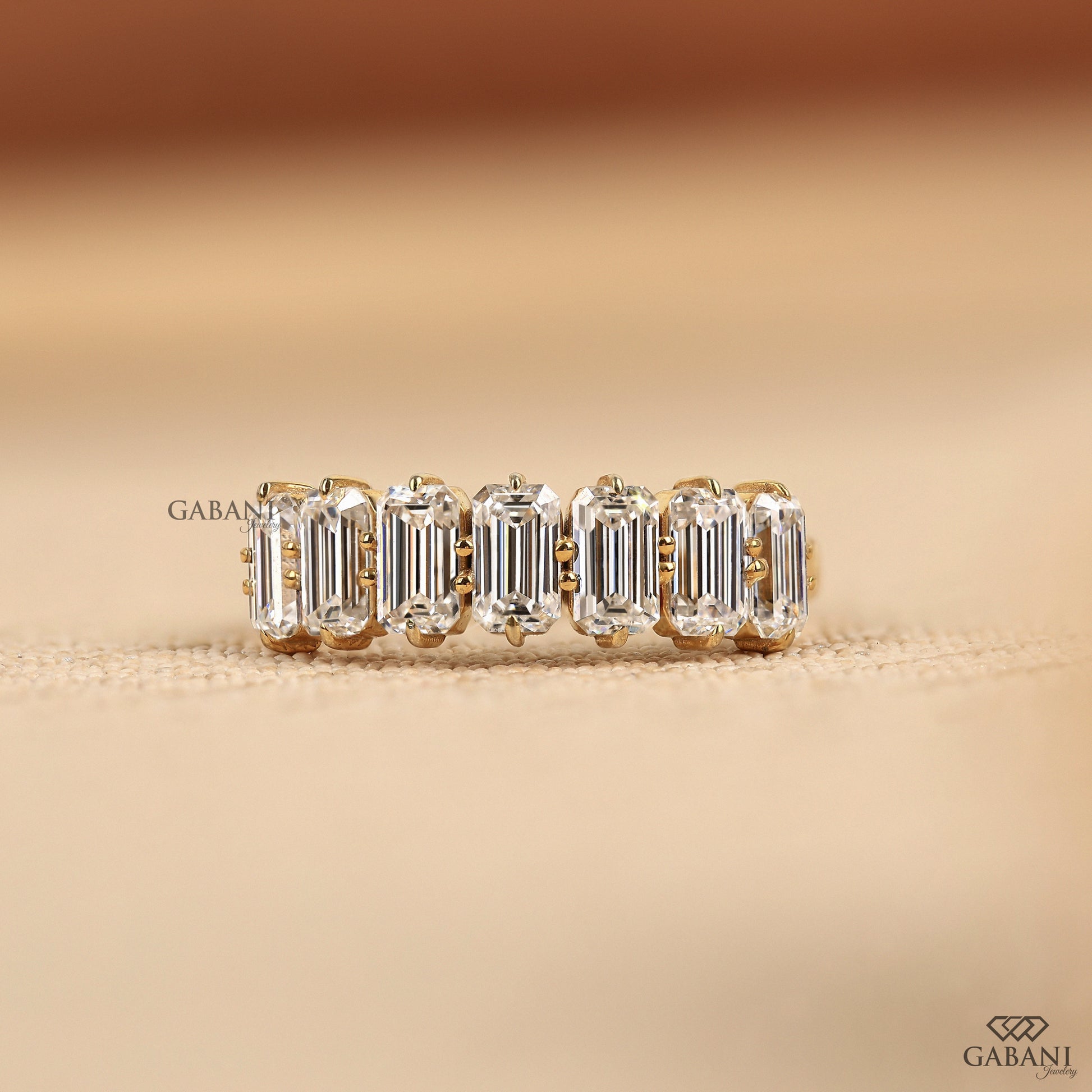 Seven stone emerald cut lab grown diamond half eternity ring in yellow gold