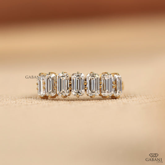 Seven stone emerald cut lab grown diamond half eternity ring in yellow gold