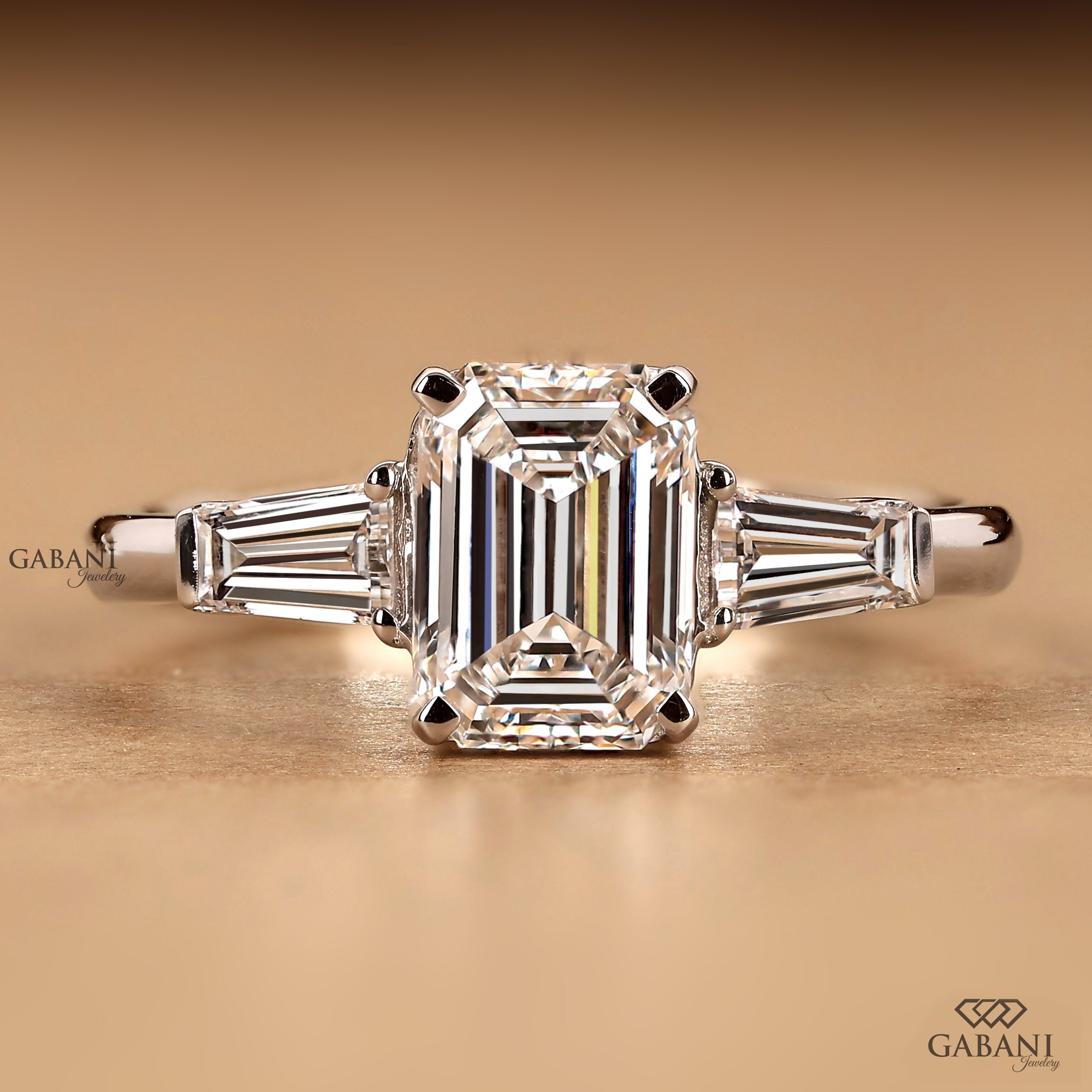 Emerald cut lab grown diamond three stone engagement ring by Gabani Jewelry