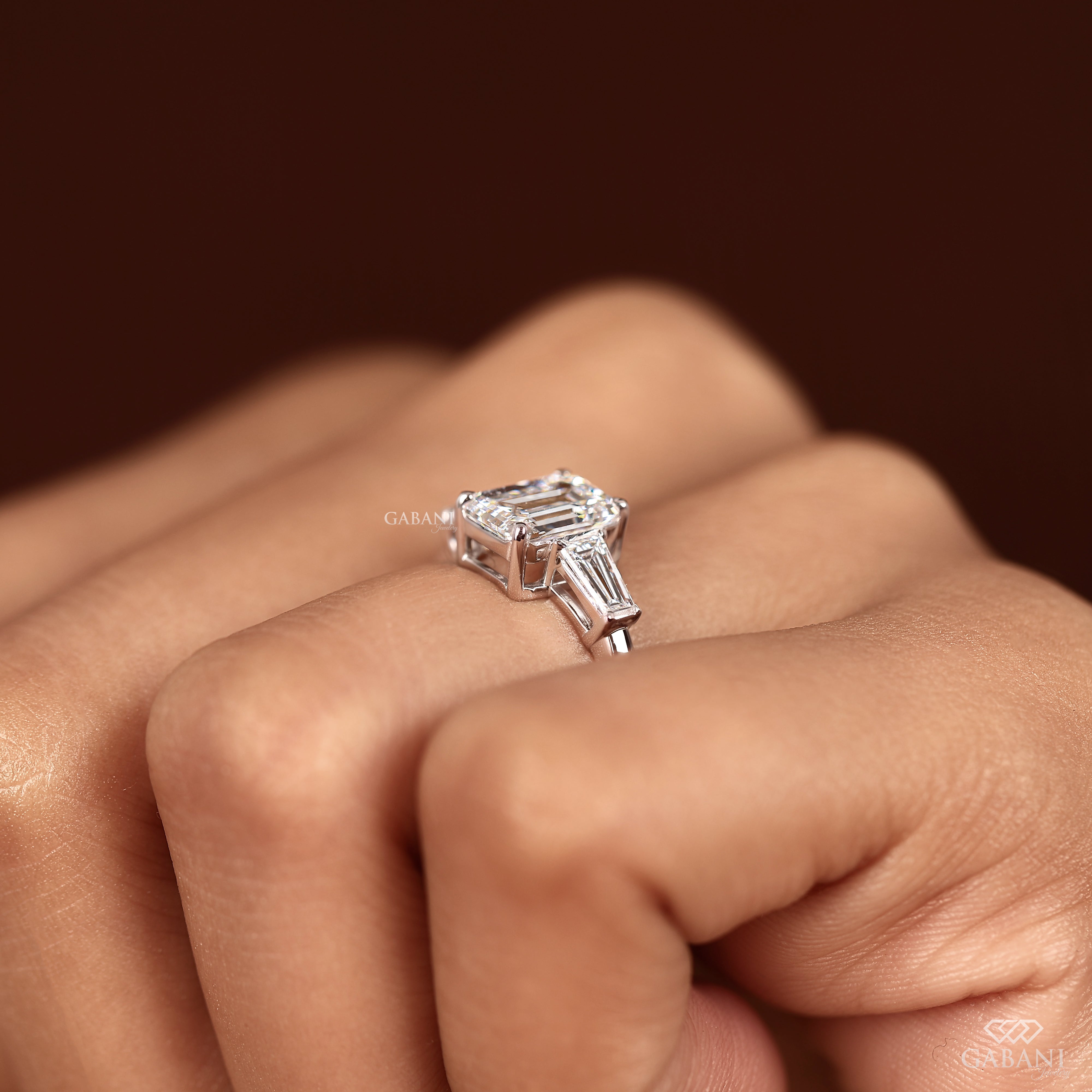 Lab grown diamond engagement ring with emerald cut center in white gold