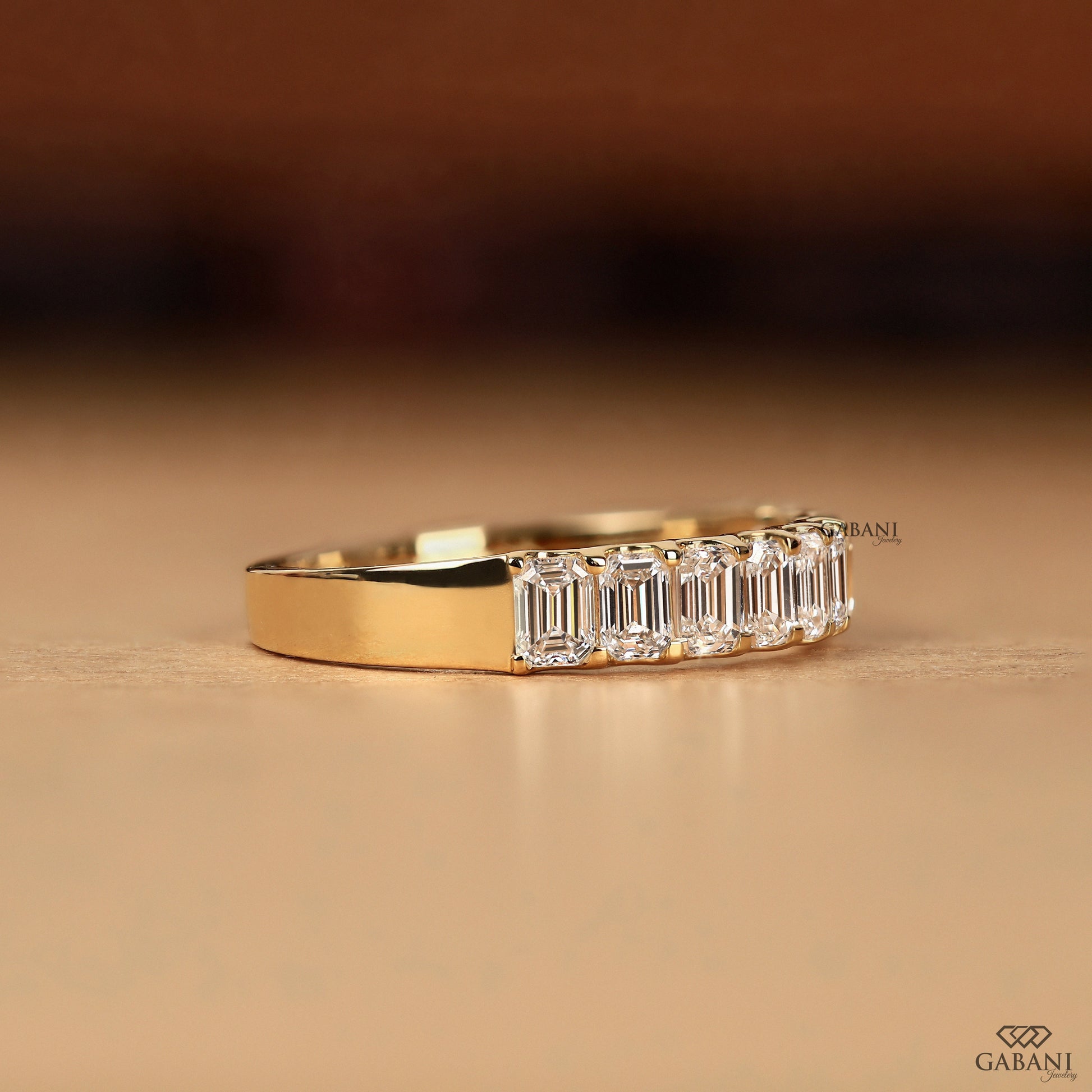 emerald cut lab diamond wedding band in yellow gold with smooth comfort fit and structured layout
