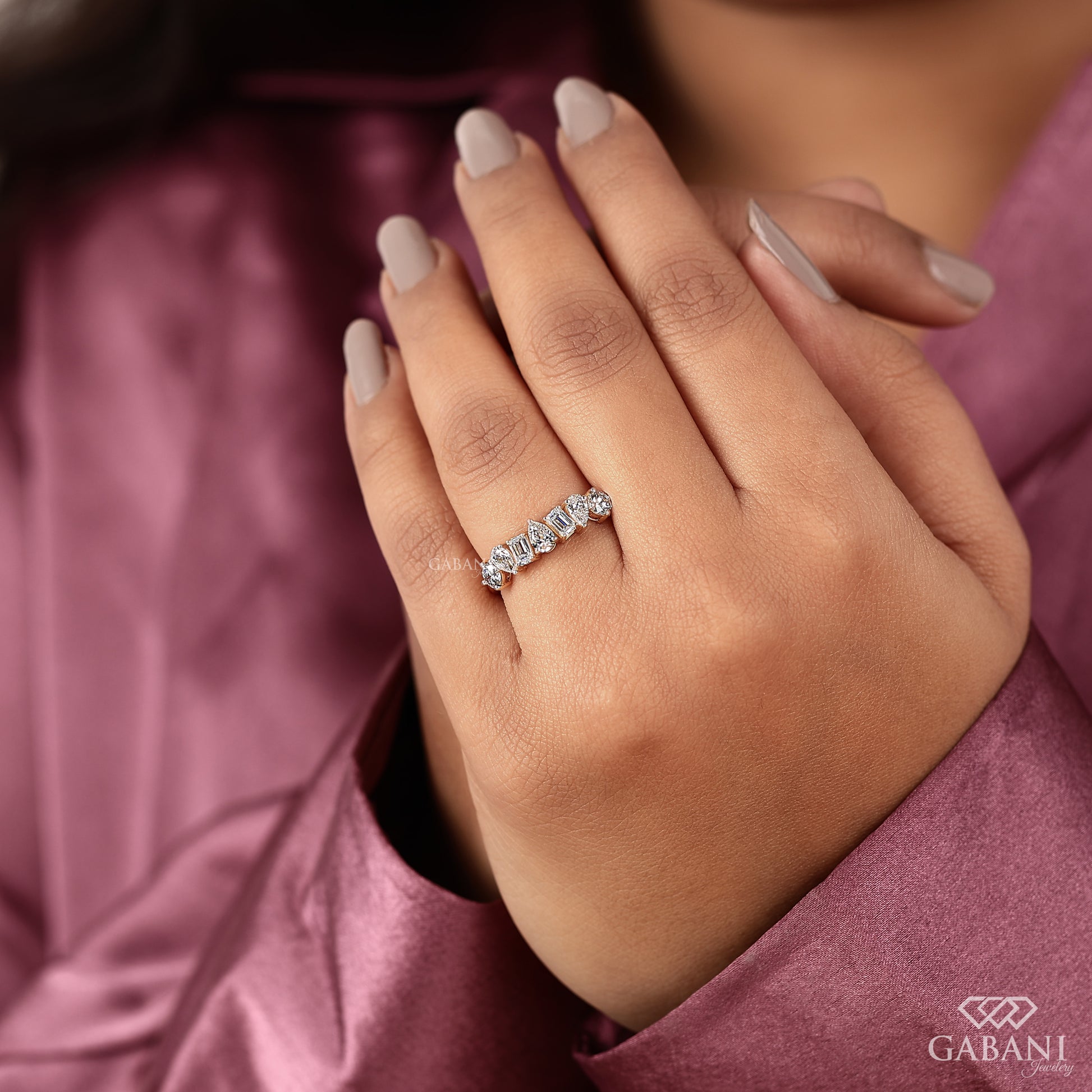 Yellow gold diamond band with emerald pear and round cut lab grown stones