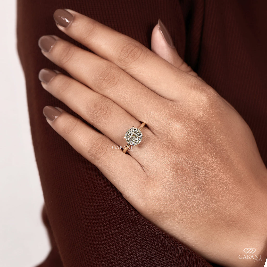 Round cut lab grown diamond solitaire engagement ring with four-prong setting and polished yellow gold band.