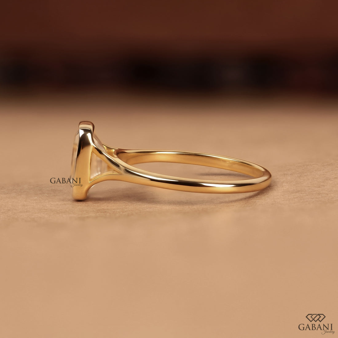 emerald cut diamond solitaire engagement ring with full bezel setting in yellow gold