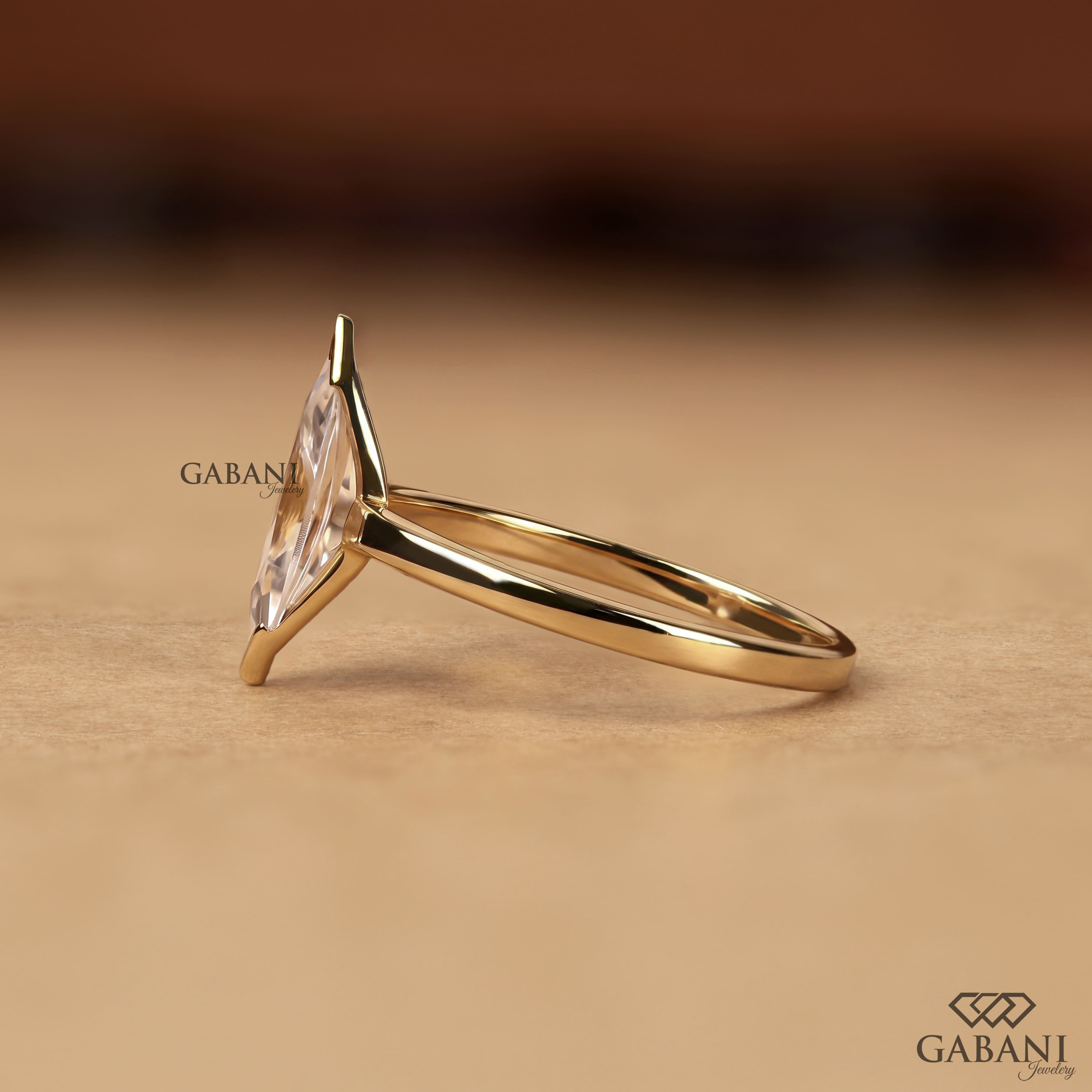 marquise scut lab grown diamond solitaire engagement ring with half bezel etting and polished 14K yellow gold band