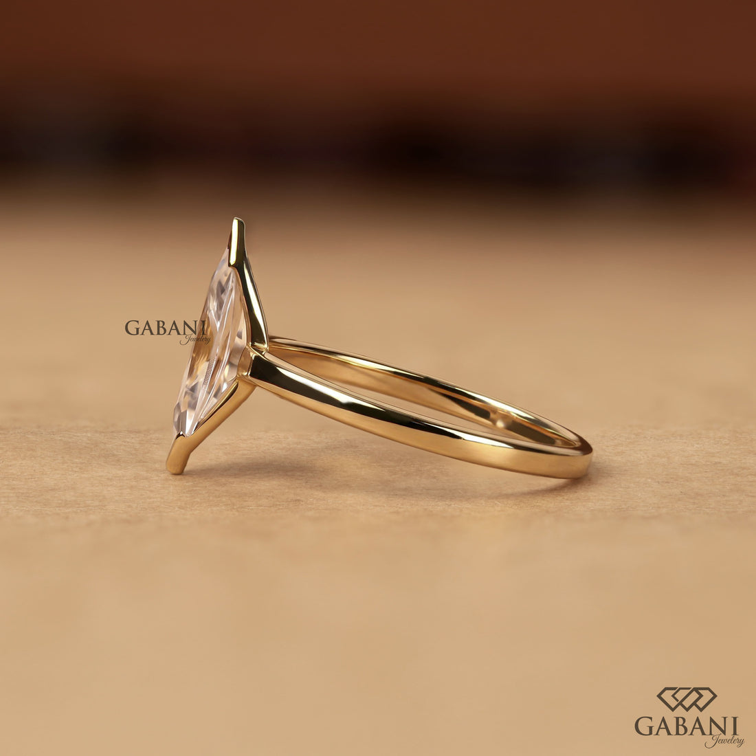 marquise scut lab grown diamond solitaire engagement ring with half bezel etting and polished 14K yellow gold band