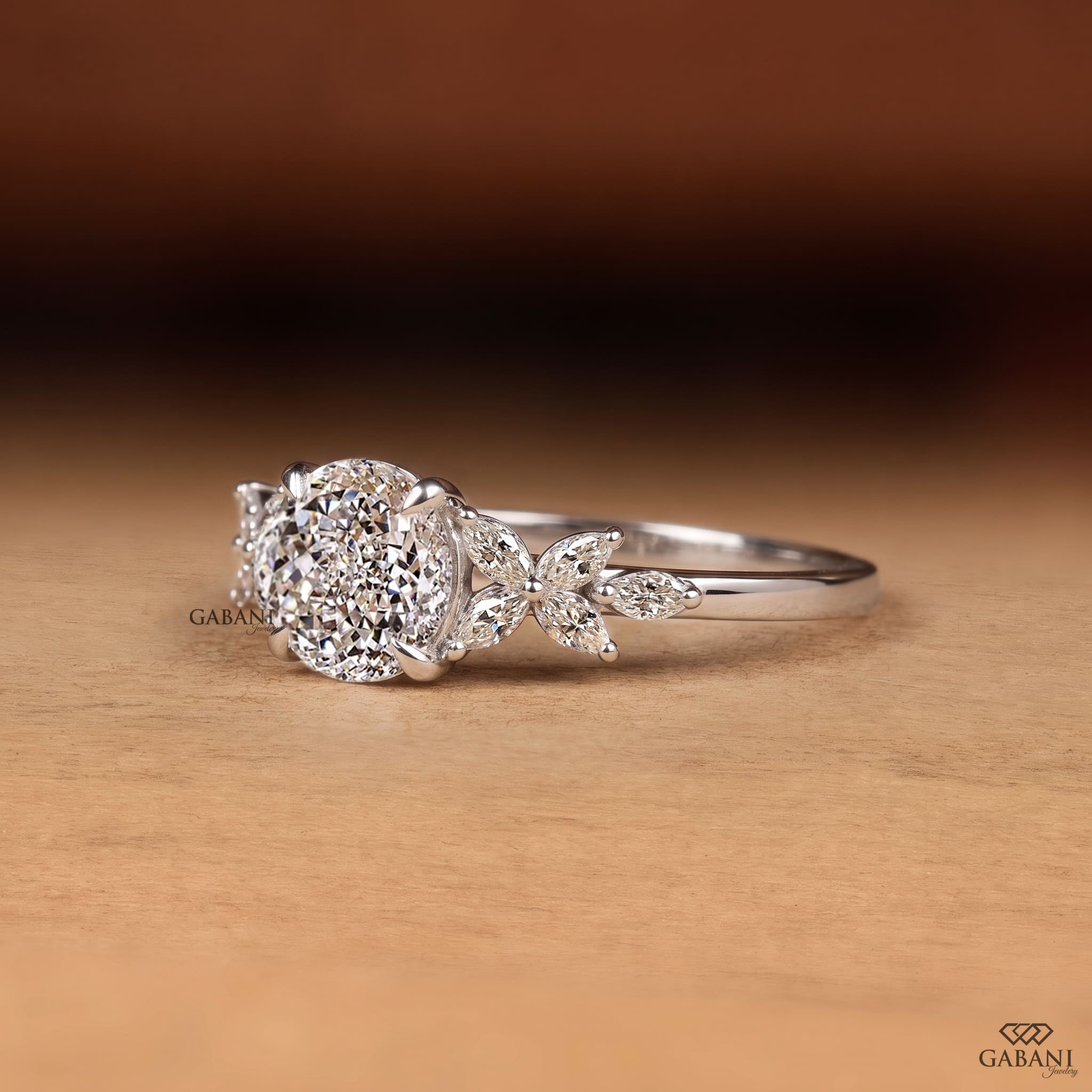 Round Portuguese cut lab grown diamond engagement ring with marquise leaf side stones in polished white gold.