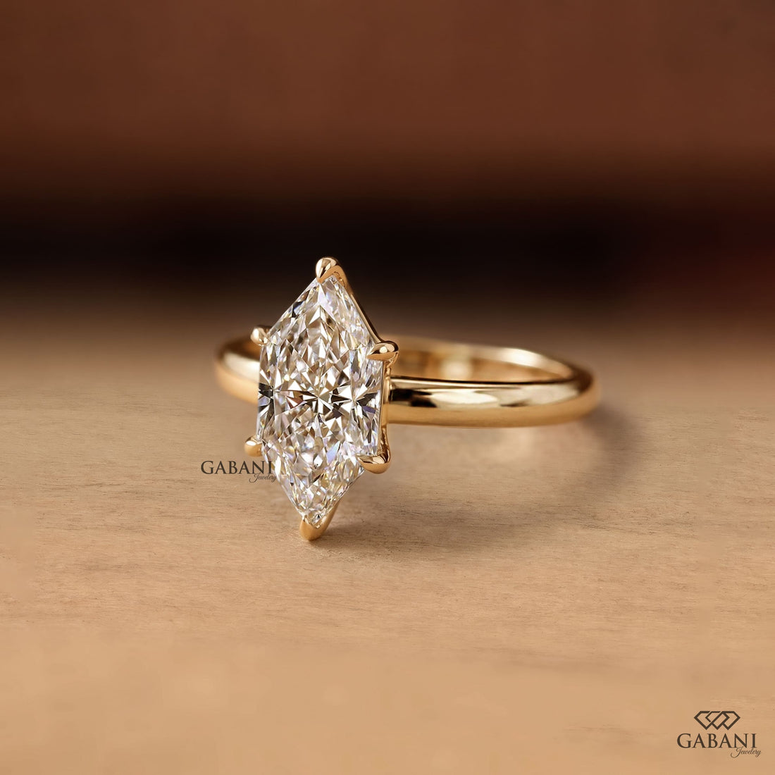 Marquise cut lab grown diamond engagement ring with six prong solitaire setting and classic 18K gold band