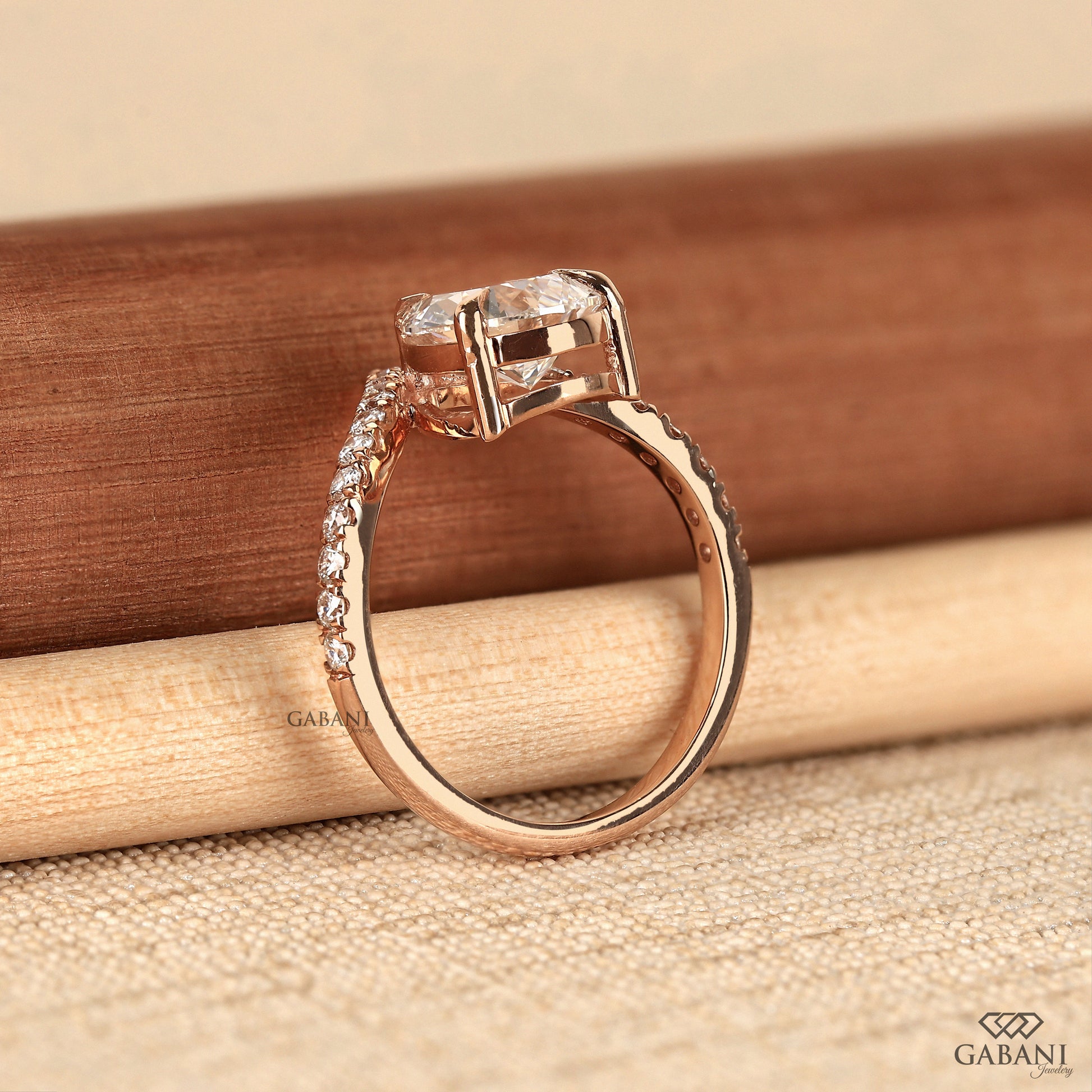 Pear cut solitaire engagement ring with round lab grown diamond accents