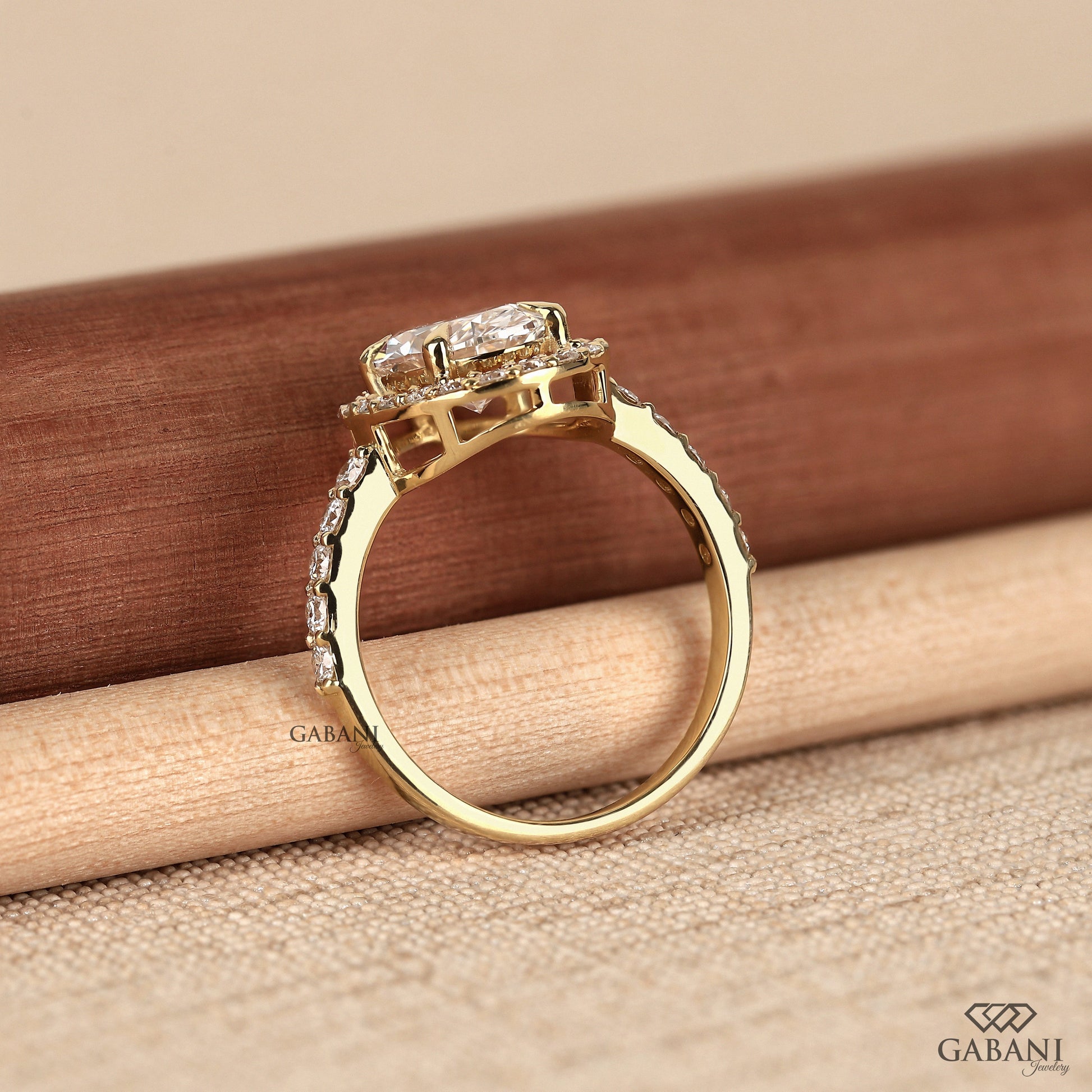 Yellow gold halo ring with oval cut lab grown diamond