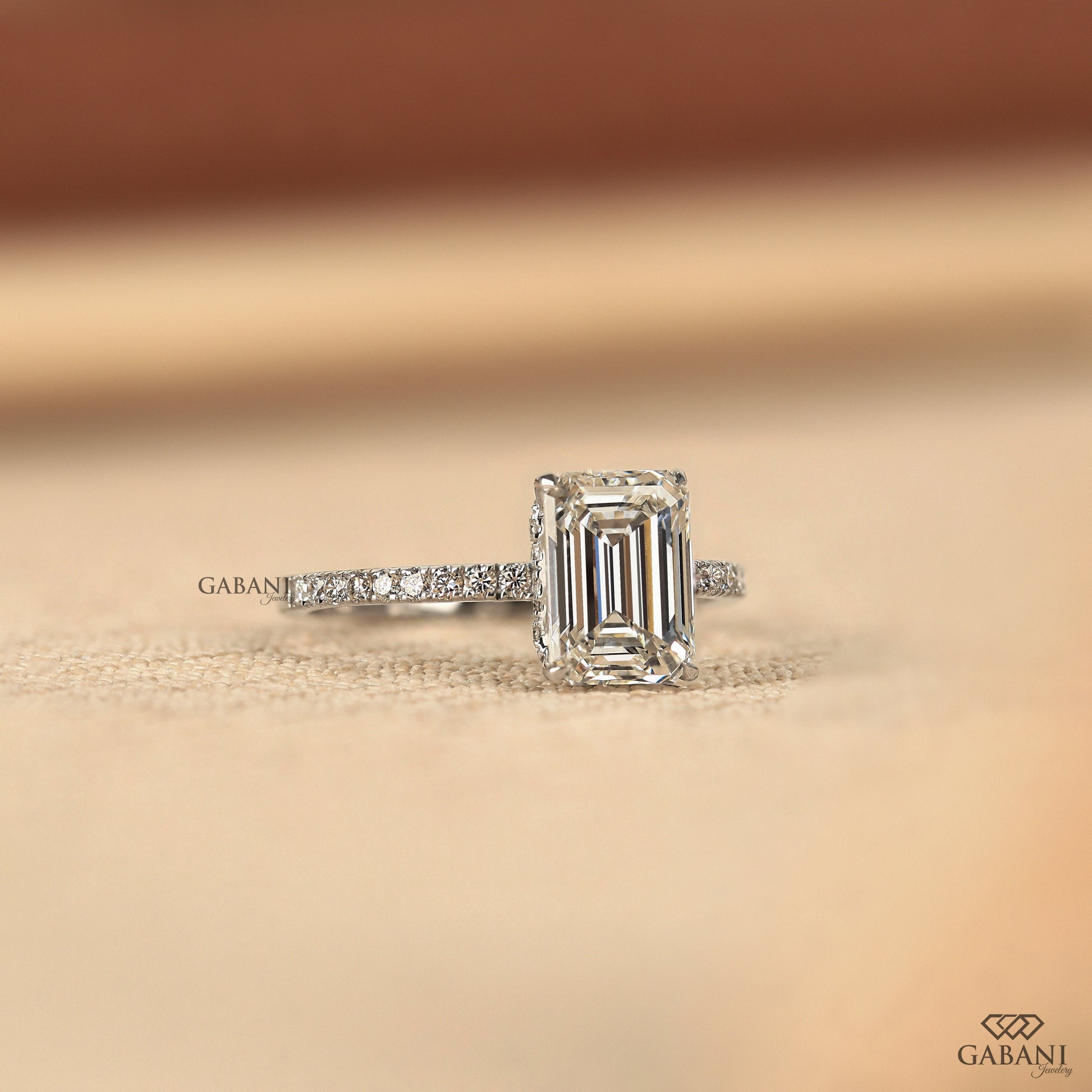 emerald cut engagement ring with lab grown diamond, prong set center, and hidden halo detail