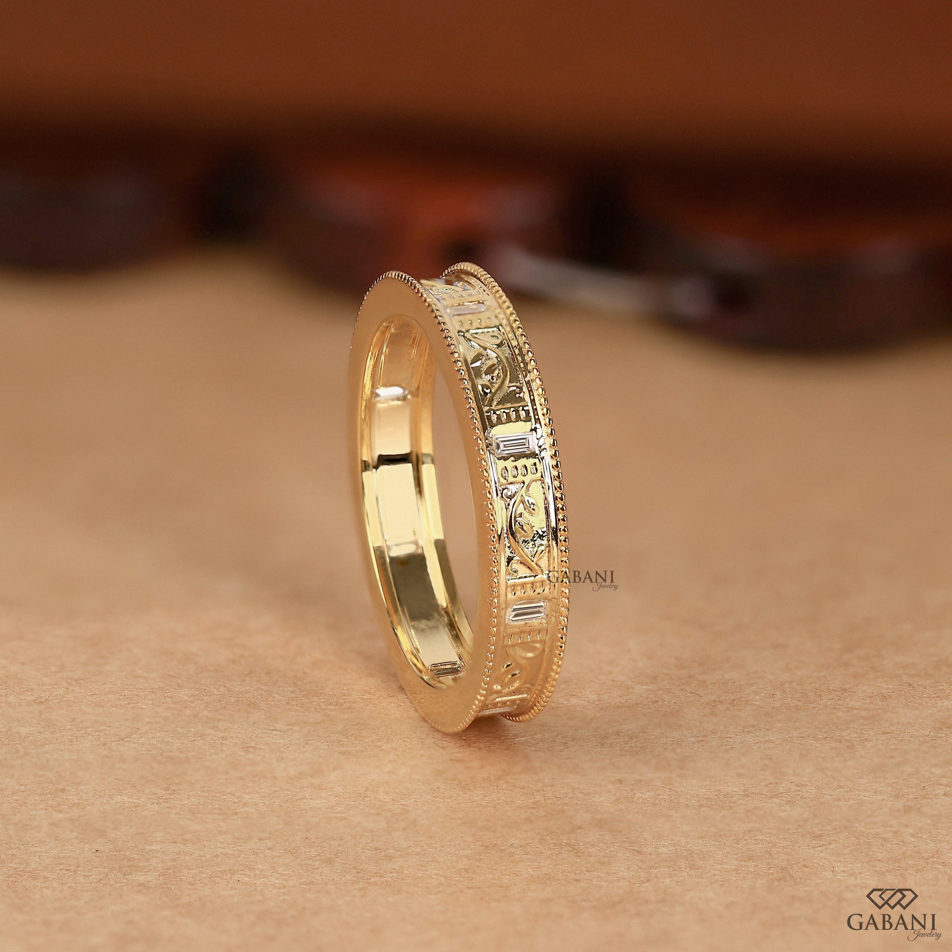 Side view of yellow gold milgrain band highlighting engraved leaf pattern and slightly raised structure with smooth balanced profile