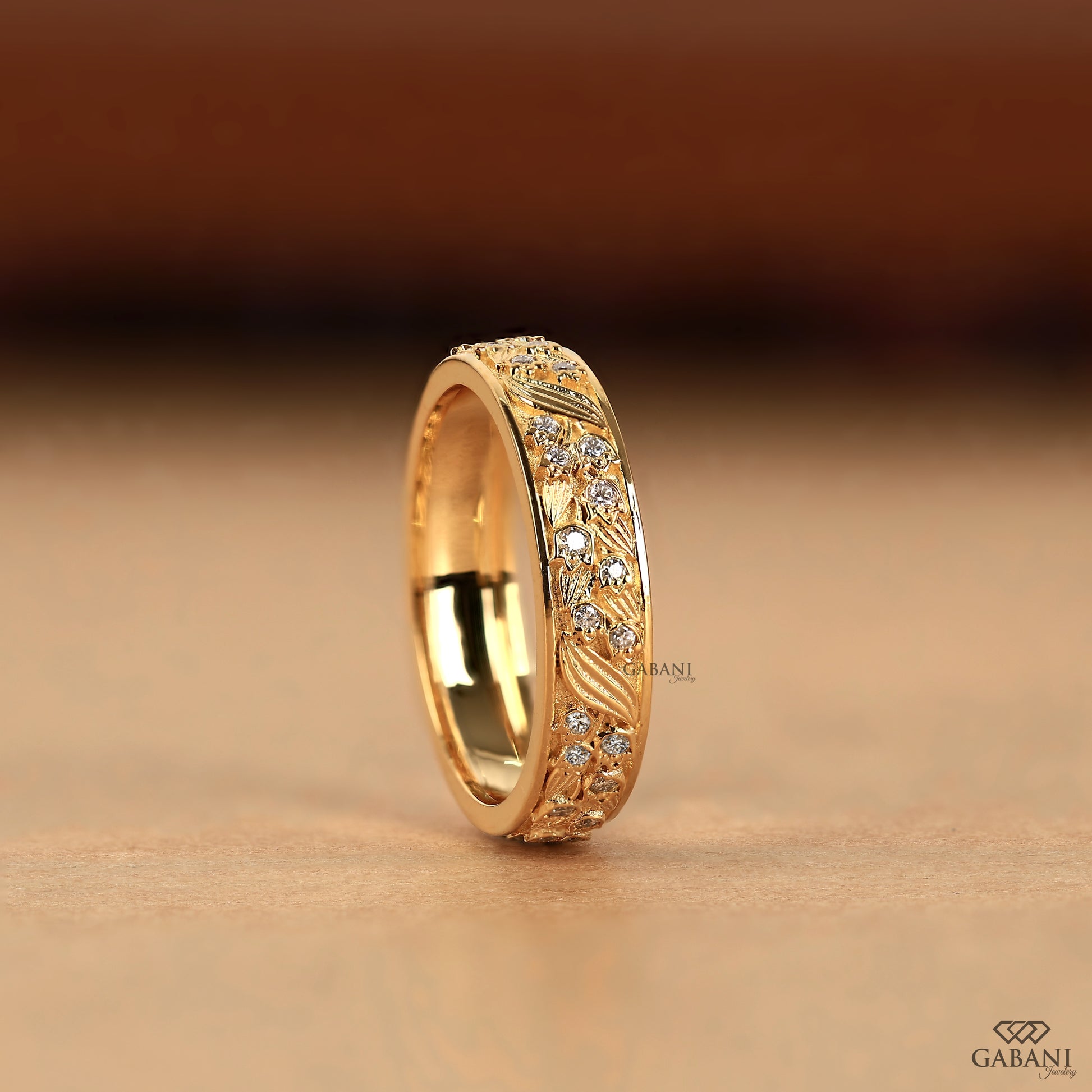 yellow gold leaf pattern eternity band with engraved nature style details