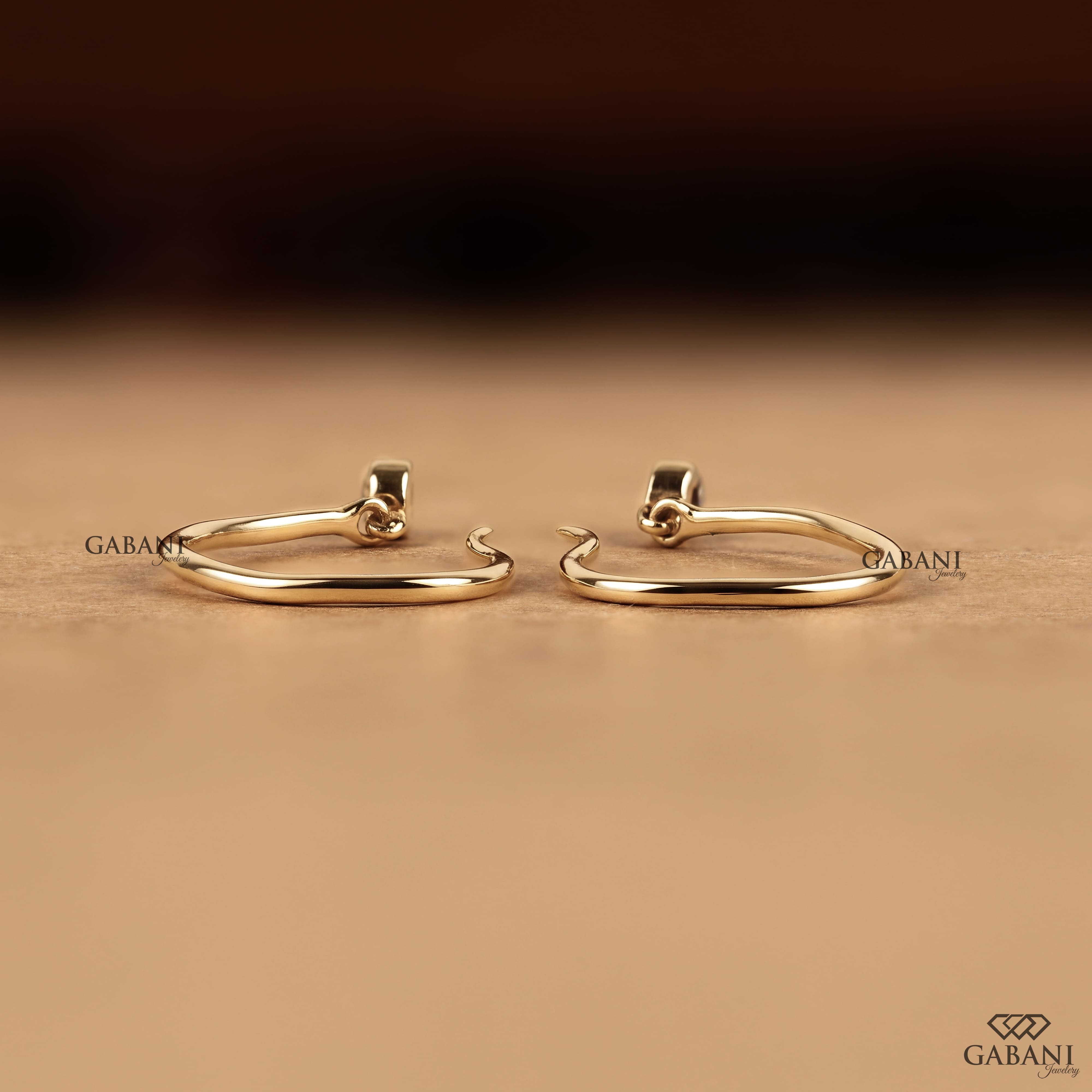 Round cut lab grown diamond hook earrings with 0.10 CTW, bezel set stones and a slim curved gold drop design for everyday wear.
