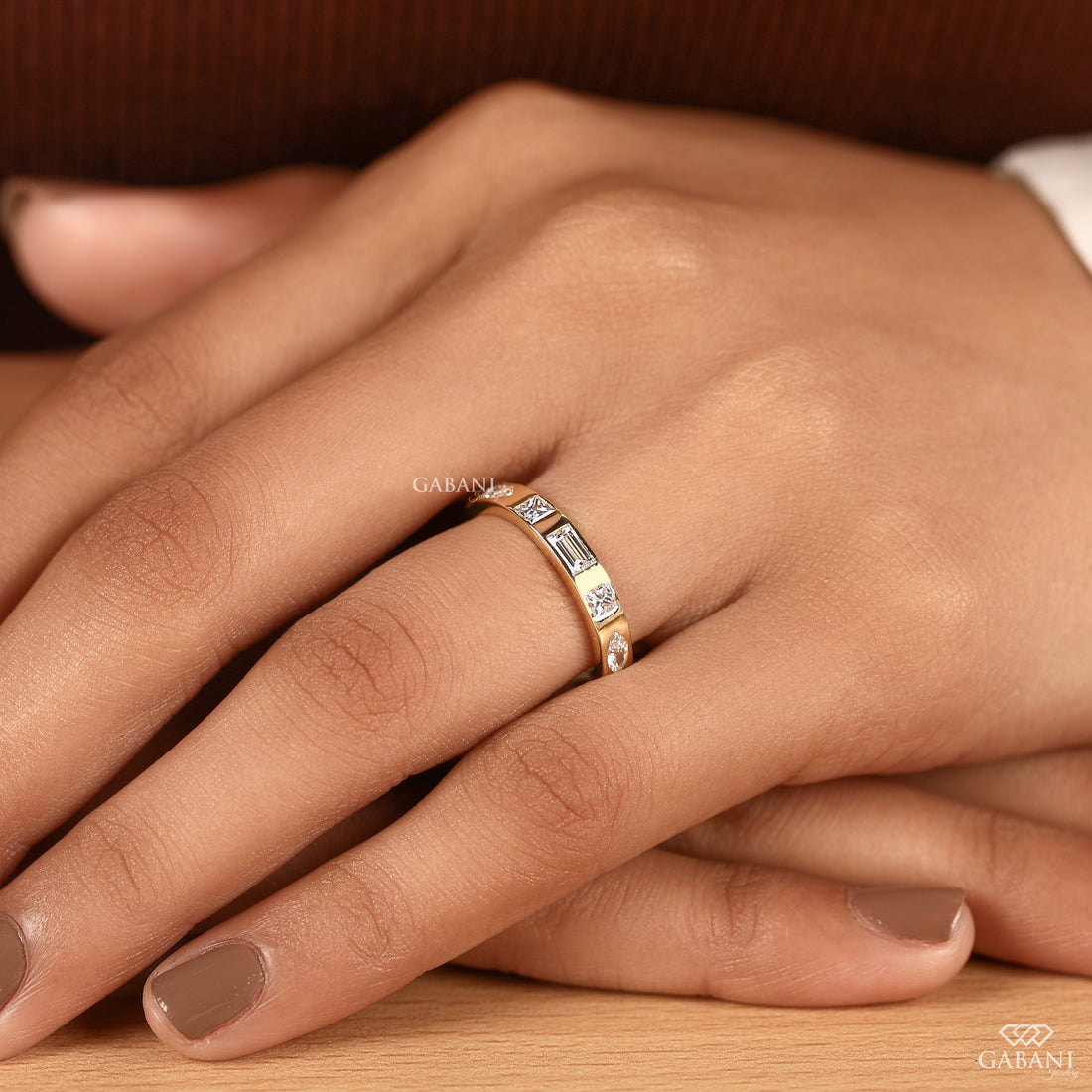 Flat 14K yellow gold eternity wedding band featuring flush set princess, baguette, round, and marquise lab grown diamonds for bridal and anniversary jewelry.