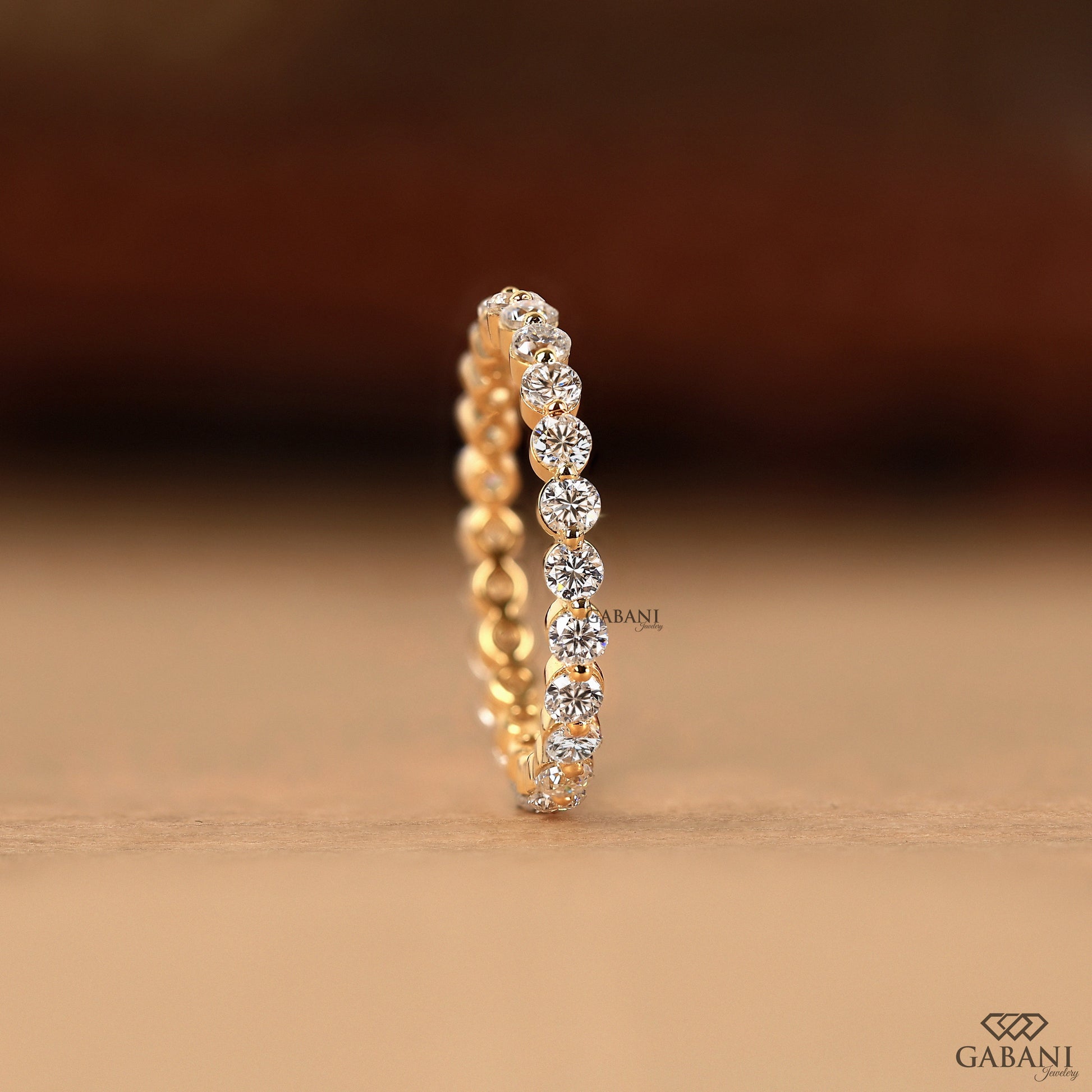 round cut lab diamond wedding band in gold by gabani jewelry