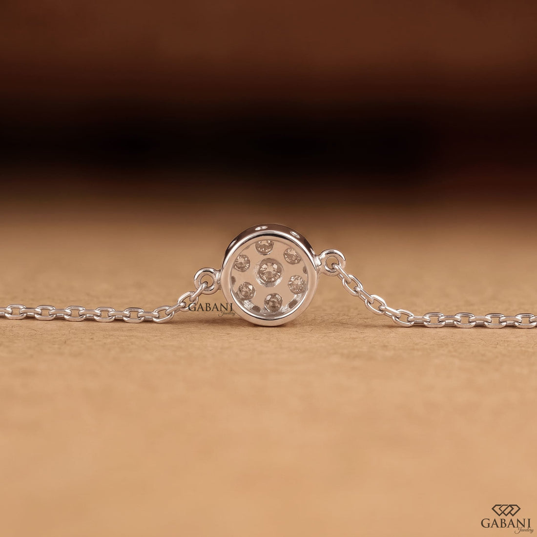 Seven stone round cut lab grown diamond floral cluster necklace in 18K white gold with a delicate cable chain and prong setting.