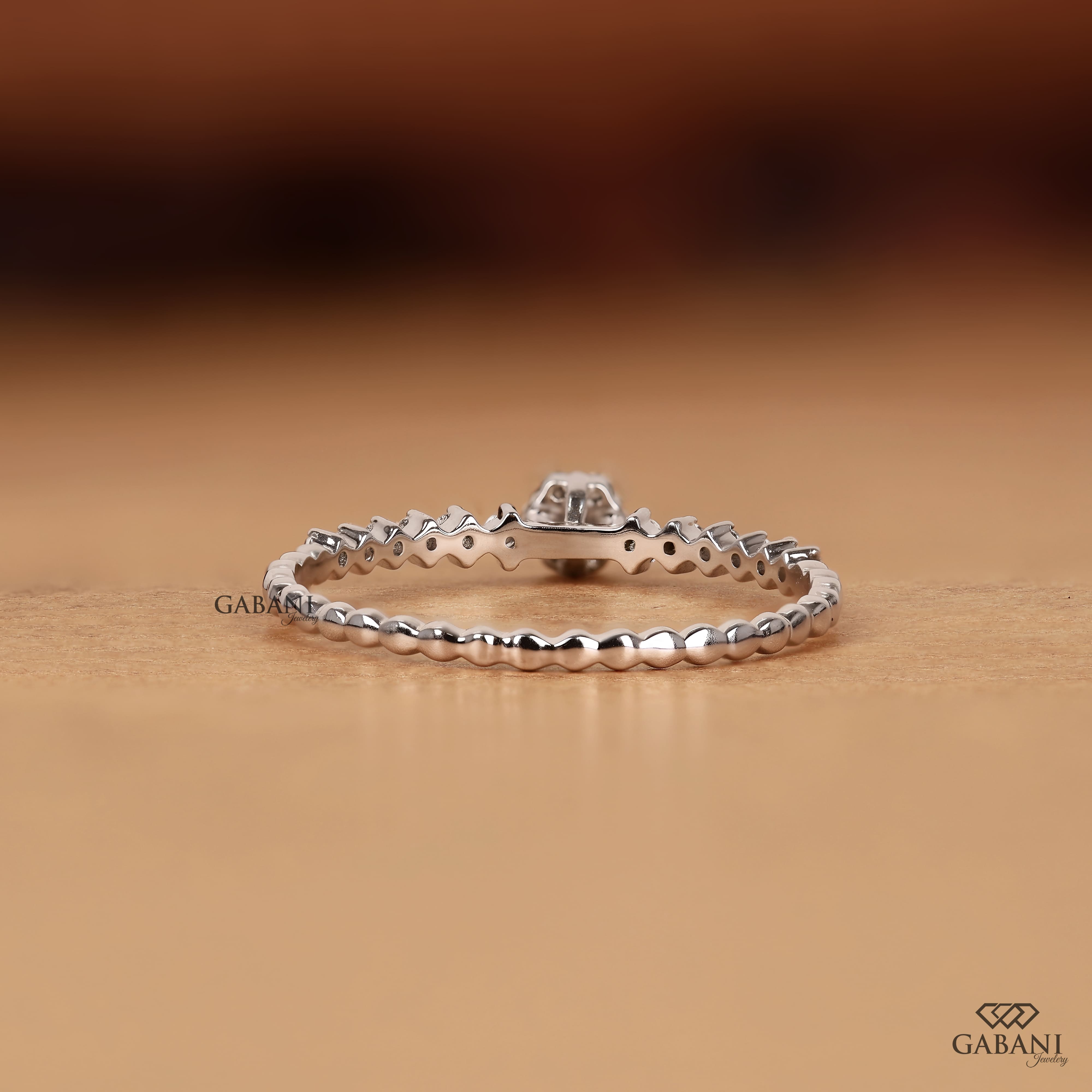 Round lab grown diamond floral cluster wedding band in white gold with graduated side diamonds and prong setting.