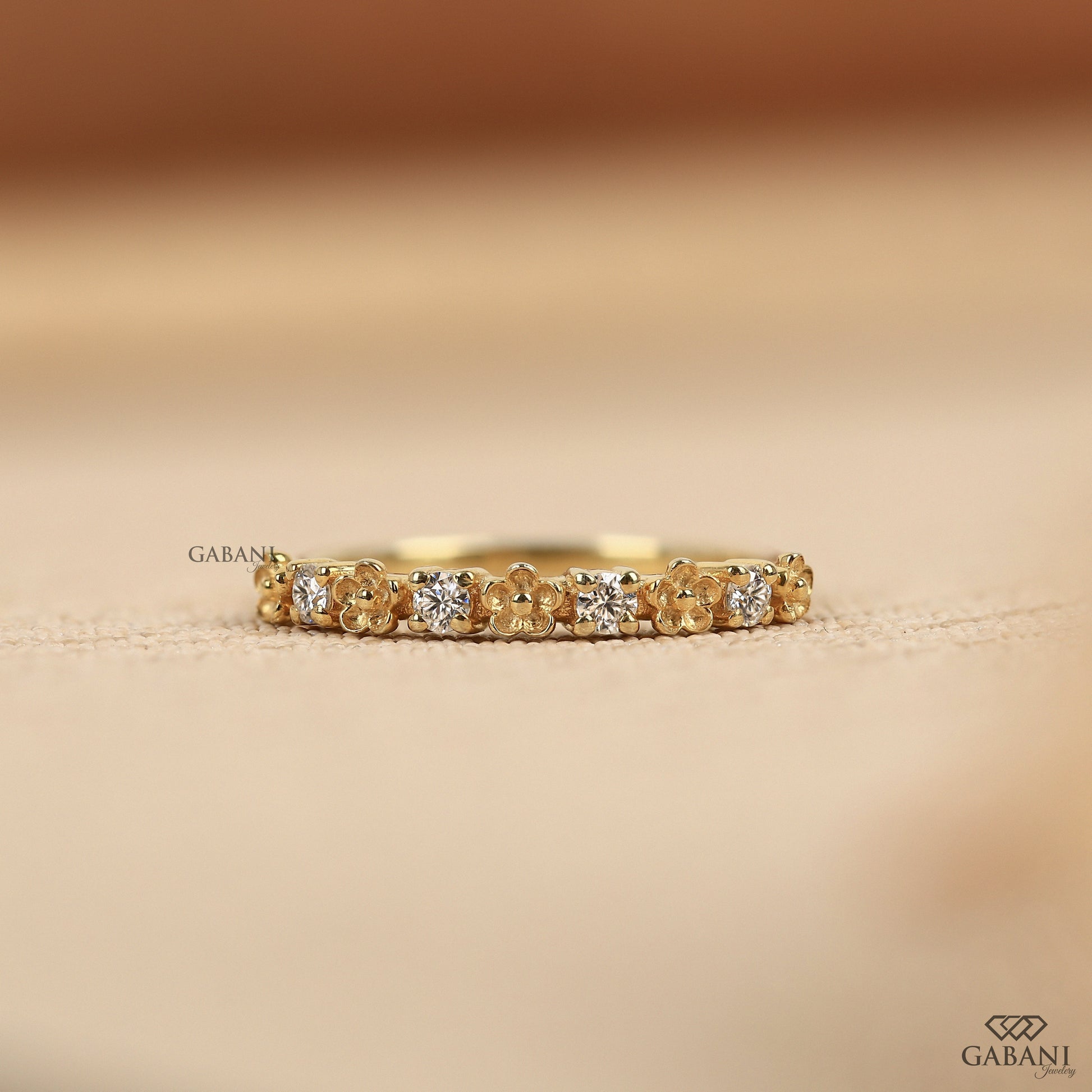 floral lab grown diamond band with a dainty nature inspired design and slim half eternity layout