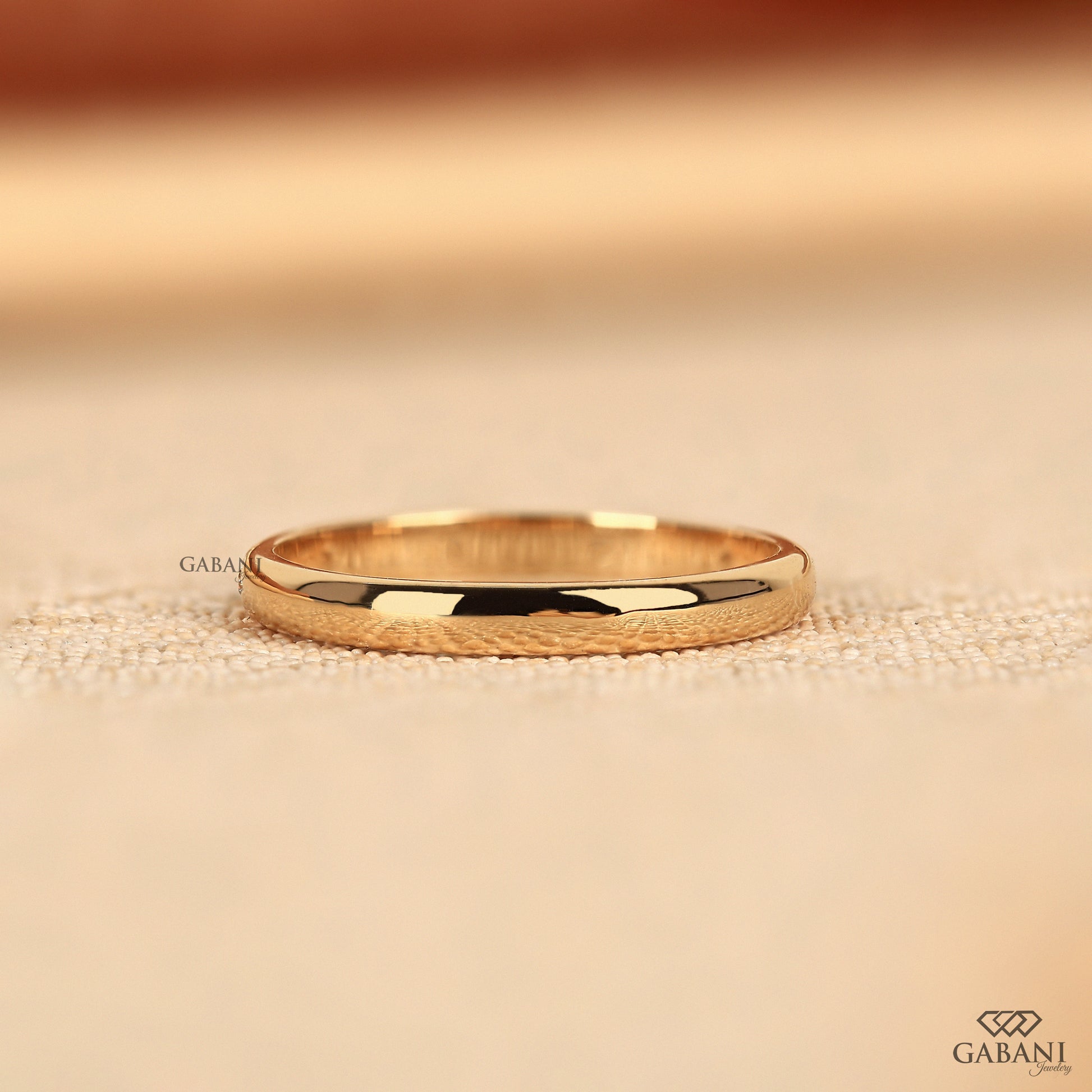 delicate yellow gold wedding band with flush set lab grown diamonds
