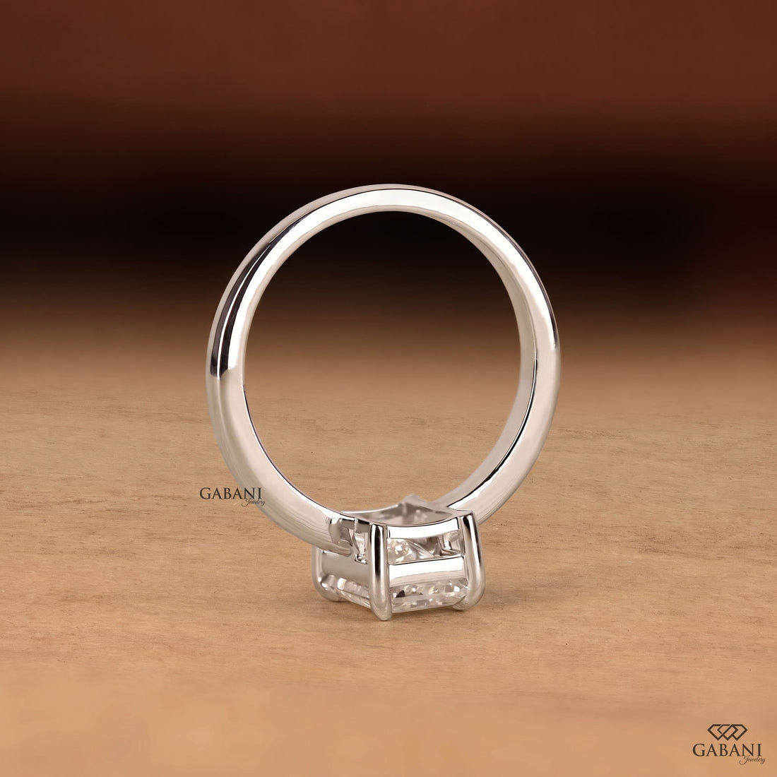 Radiant cut lab grown diamond solitaire engagement ring in 18K white gold with a classic four claw prong setting and polished band.