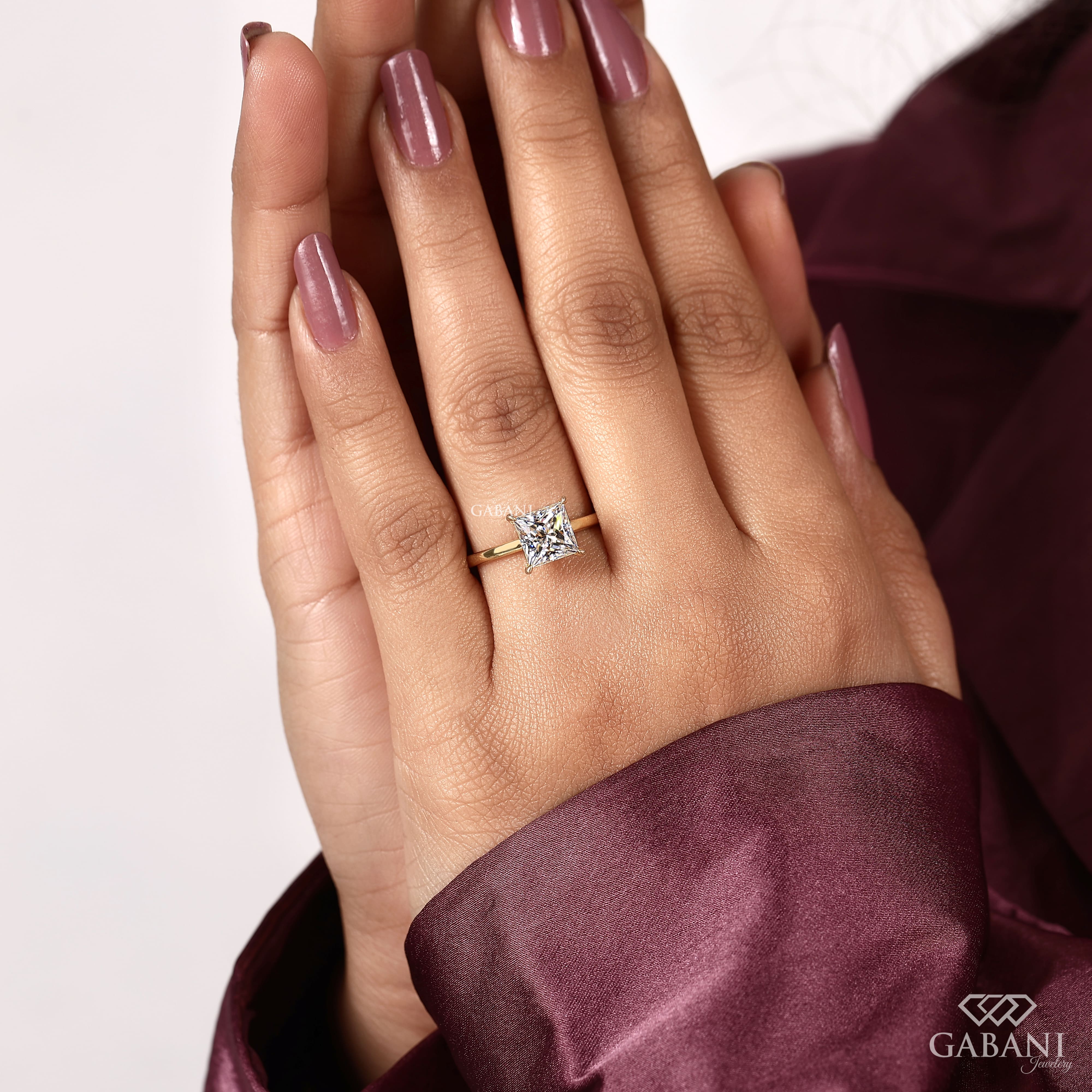 princess cut lab grown diamond solitaire engagement ring in 18K yellow gold with a classic four prong setting and polished band.