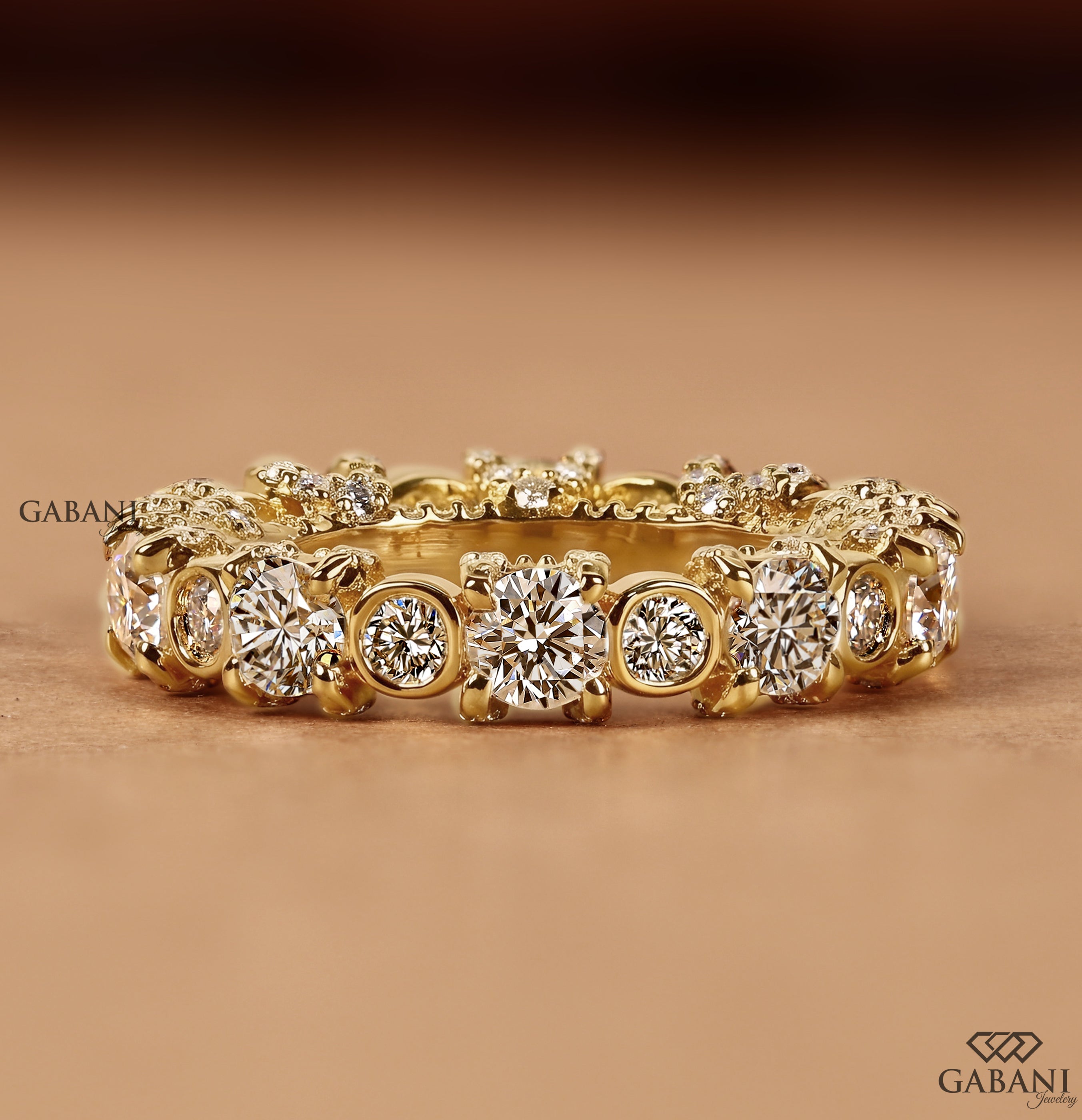 Round cut lab grown diamond wedding band with bezel and prong set stones
