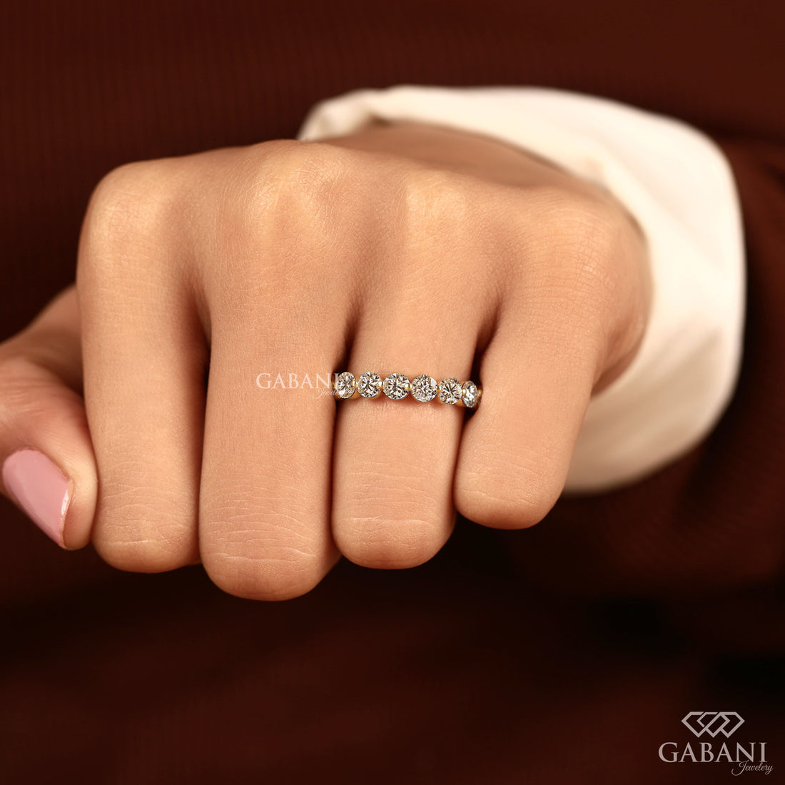 Round lab grown diamond shared prong full eternity wedding band in yellow gold with continuous diamond setting.