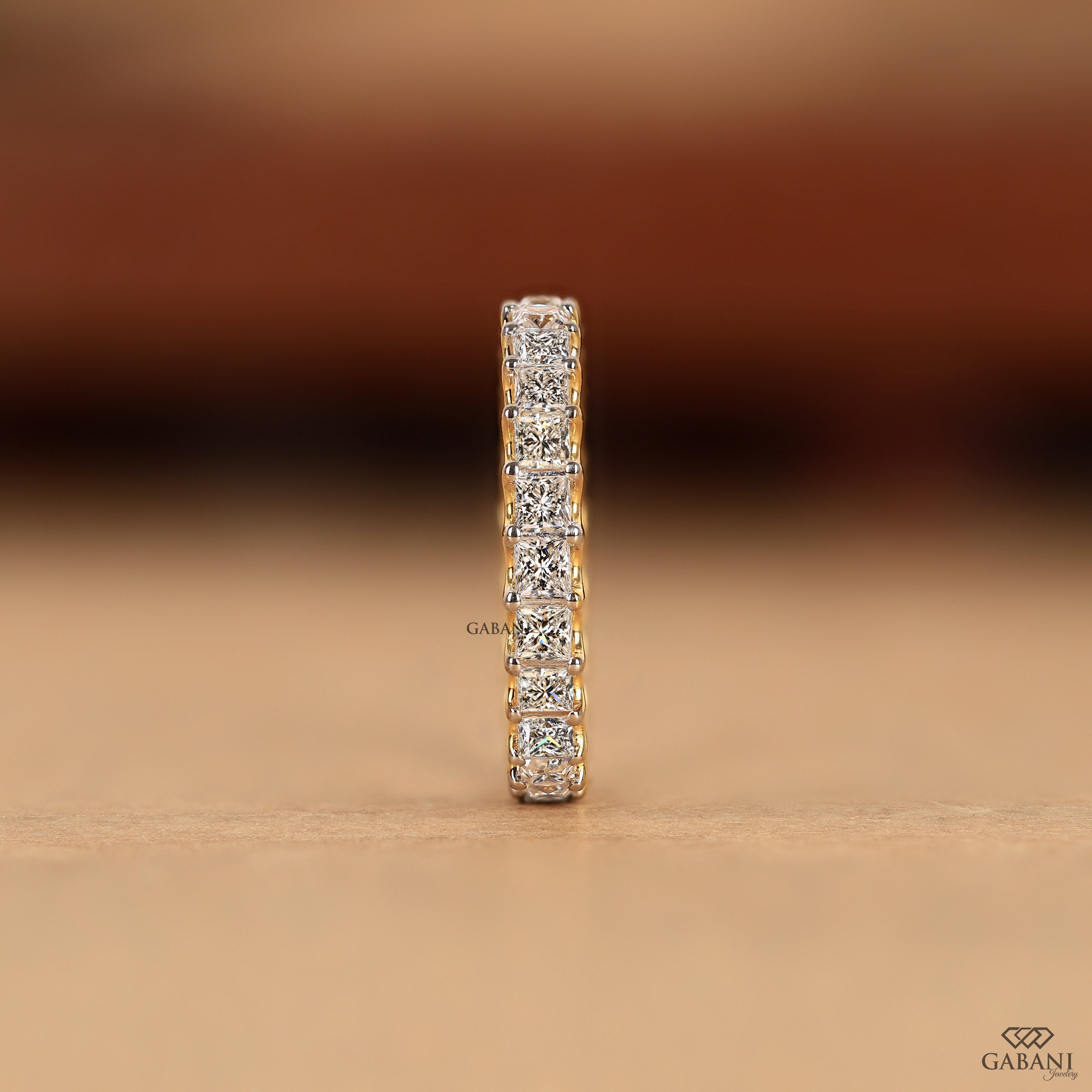 Princess cut lab grown diamond eternity band worn on a hand as a matching wedding band for everyday wear or special occasions.