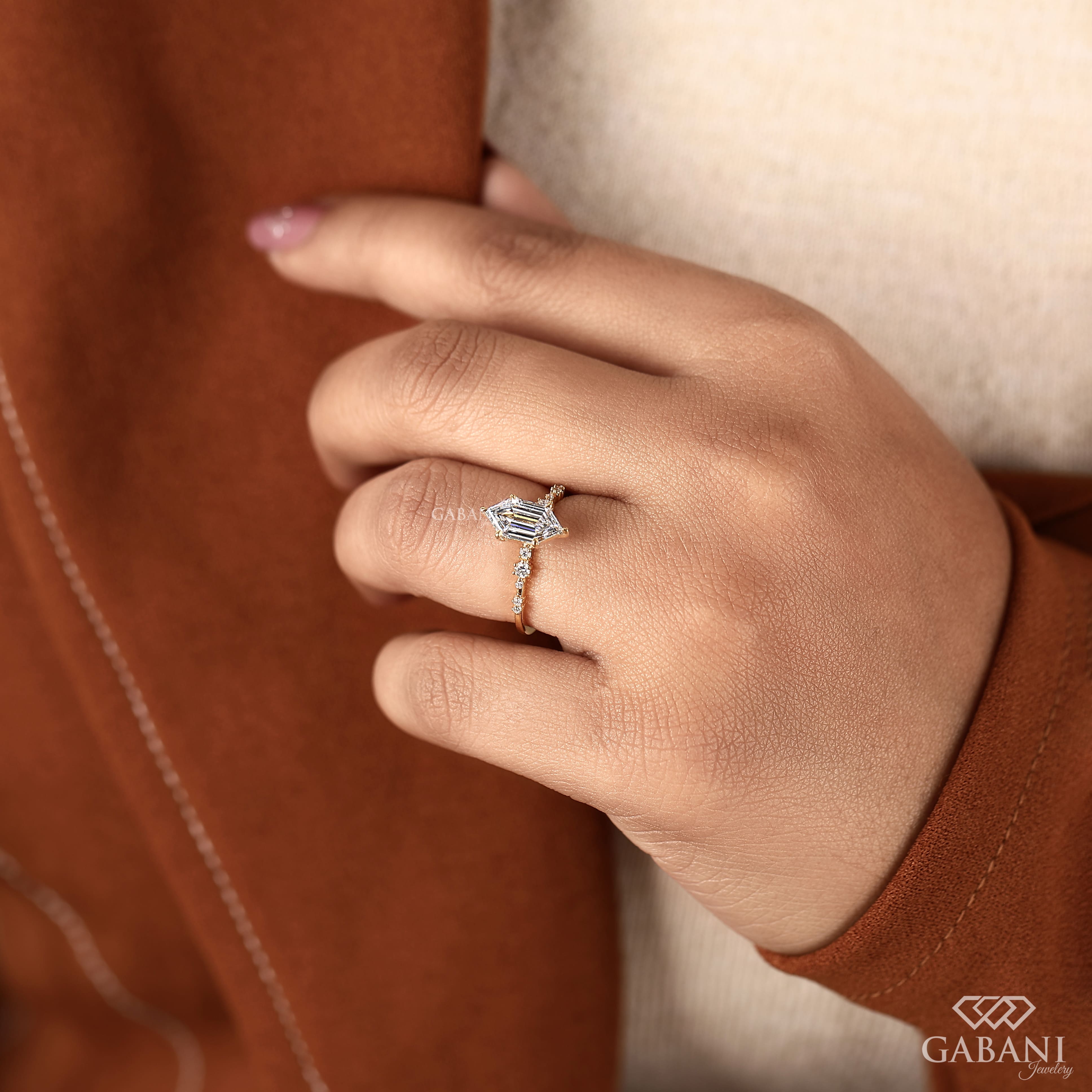 Dutch marquise lab grown diamond engagement ring with elongated geometric center stone, round side diamond accents and gold band.