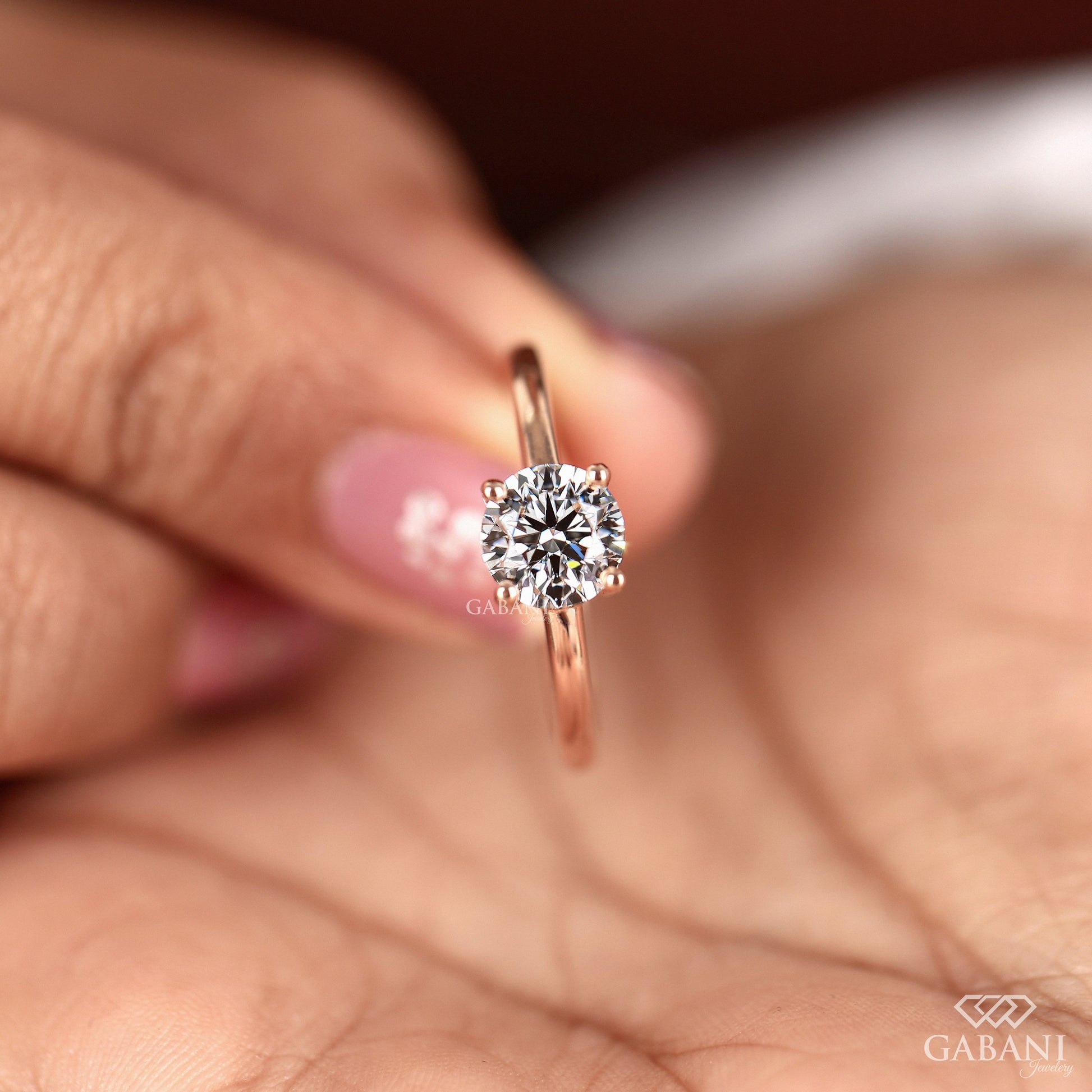 round cut lab grown diamond ring set in classic solitaire style rose gold band