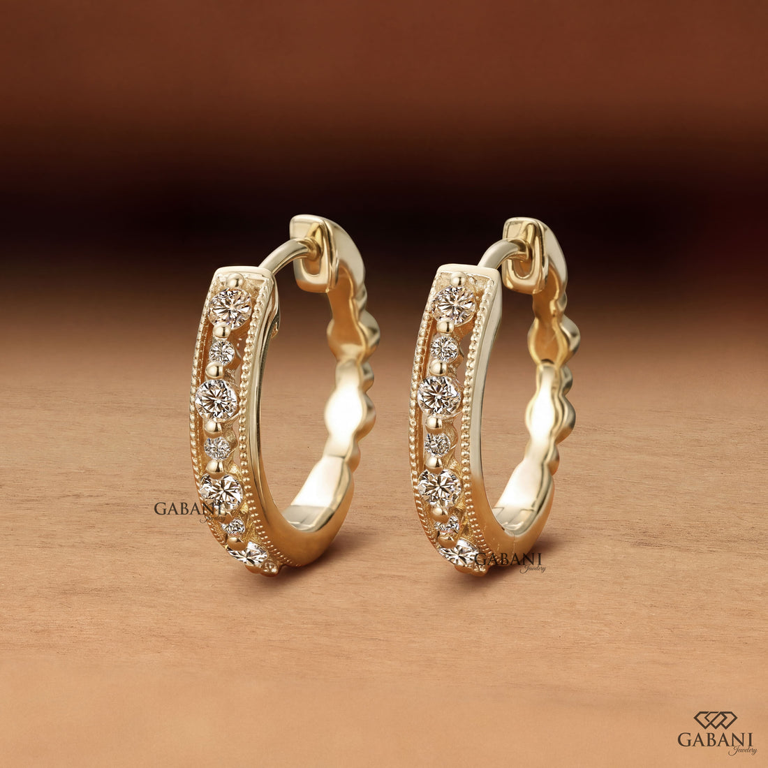 Round cut diamond milgrain hoop earrings in yellow gold with graduated diamonds