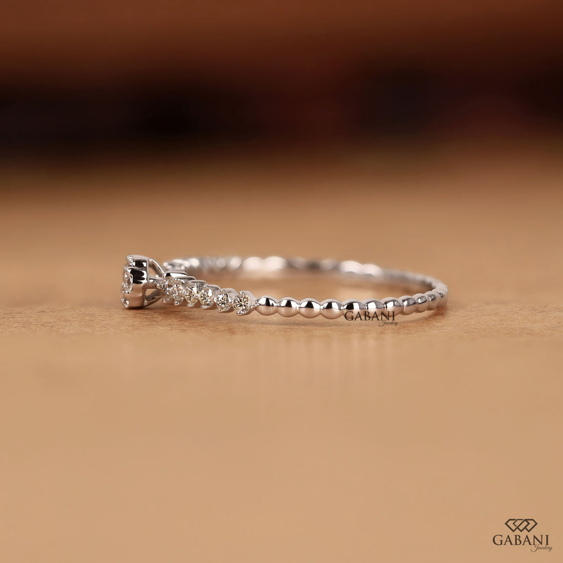 Round lab grown diamond floral cluster wedding band in white gold with graduated side diamonds and prong setting.