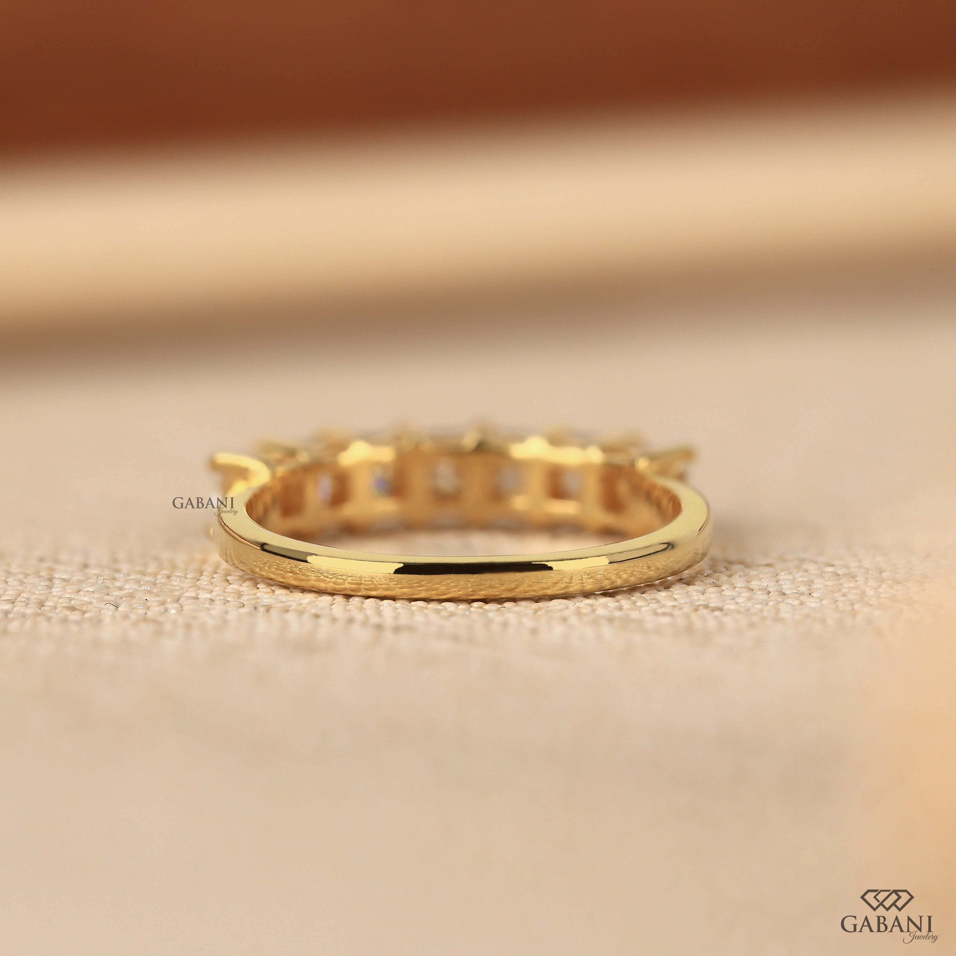 seven stone princess cut lab grown diamond wedding band in 14K yellow gold. A classic half eternity ring for weddings, anniversaries and stacking.