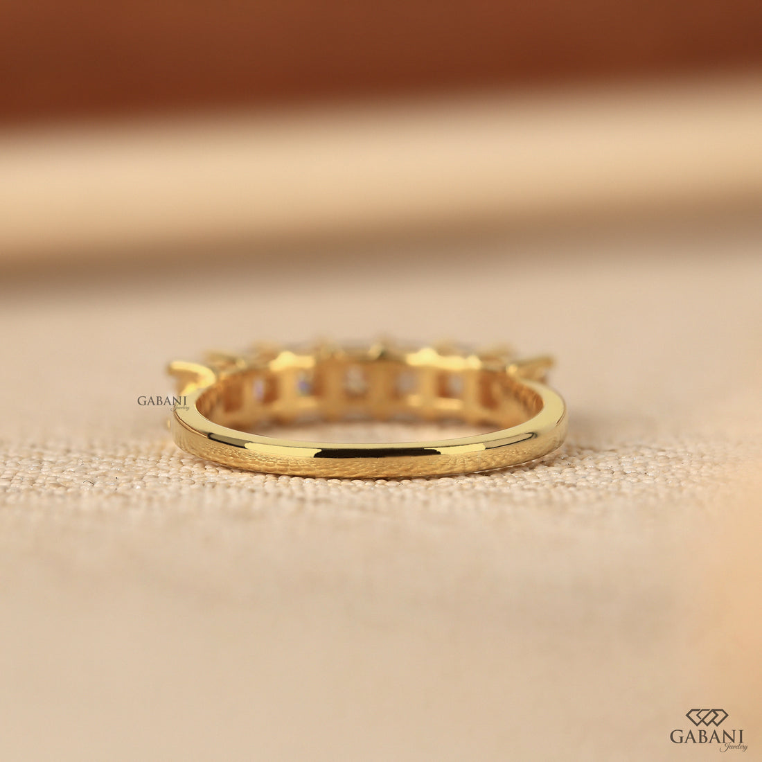 seven stone princess cut lab grown diamond wedding band in 14K yellow gold. A classic half eternity ring for weddings, anniversaries and stacking.