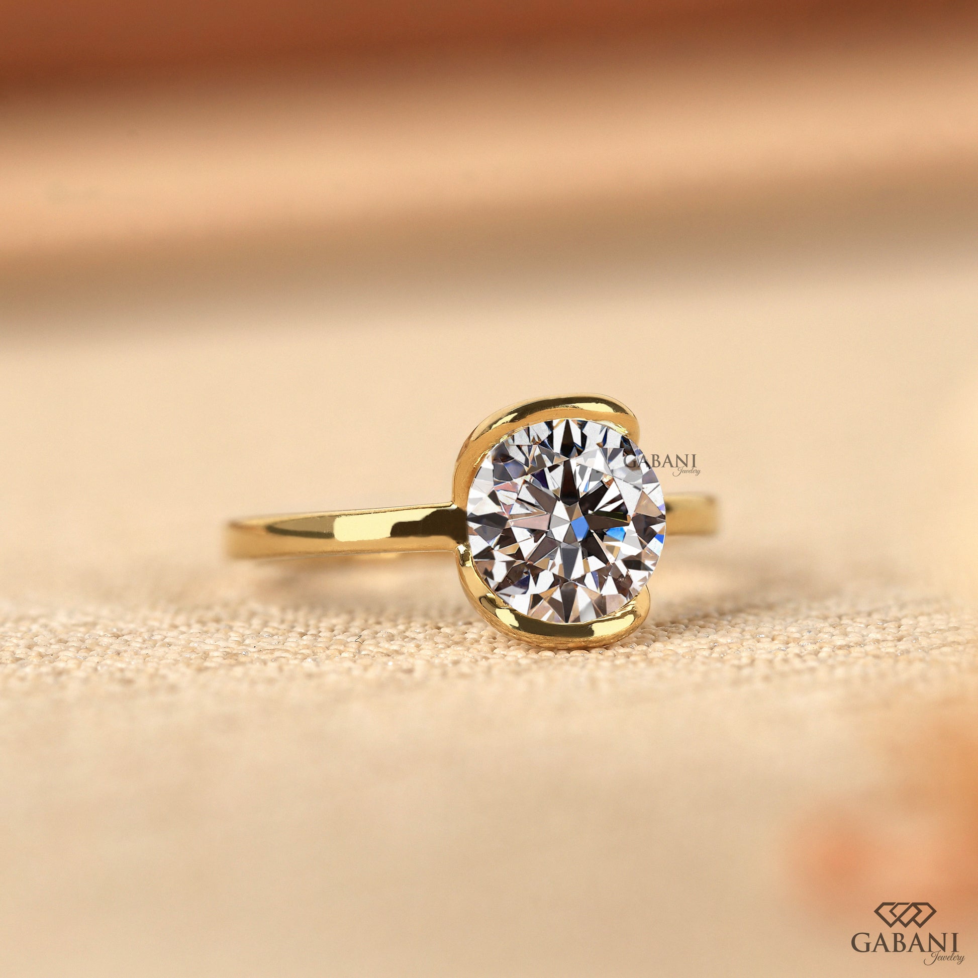 half bezel round diamond ring with split shank pipe style yellow gold band
