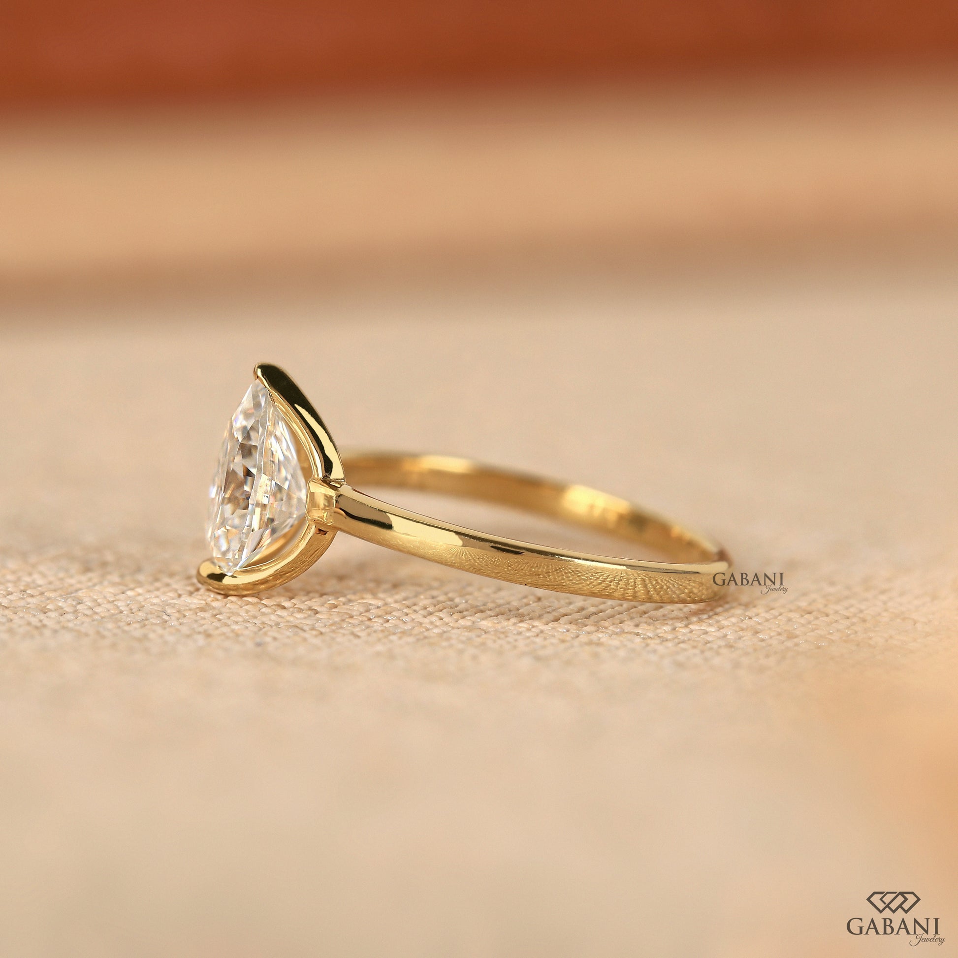 Yellow gold solitaire ring with pear cut lab grown diamond
