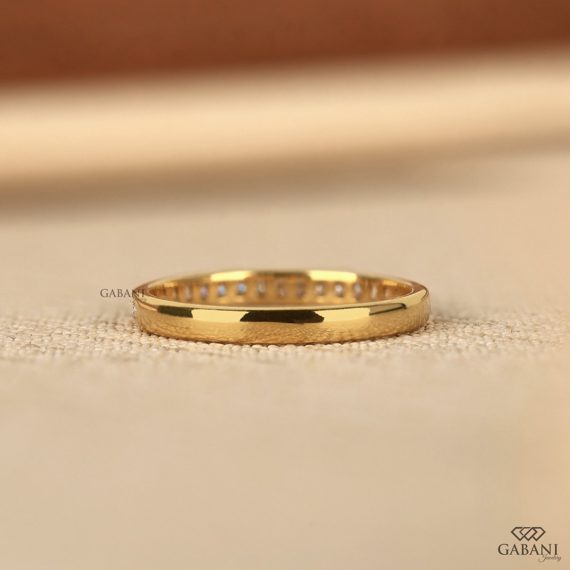 dainty half eternity band with channel set lab grown diamonds in yellow gold