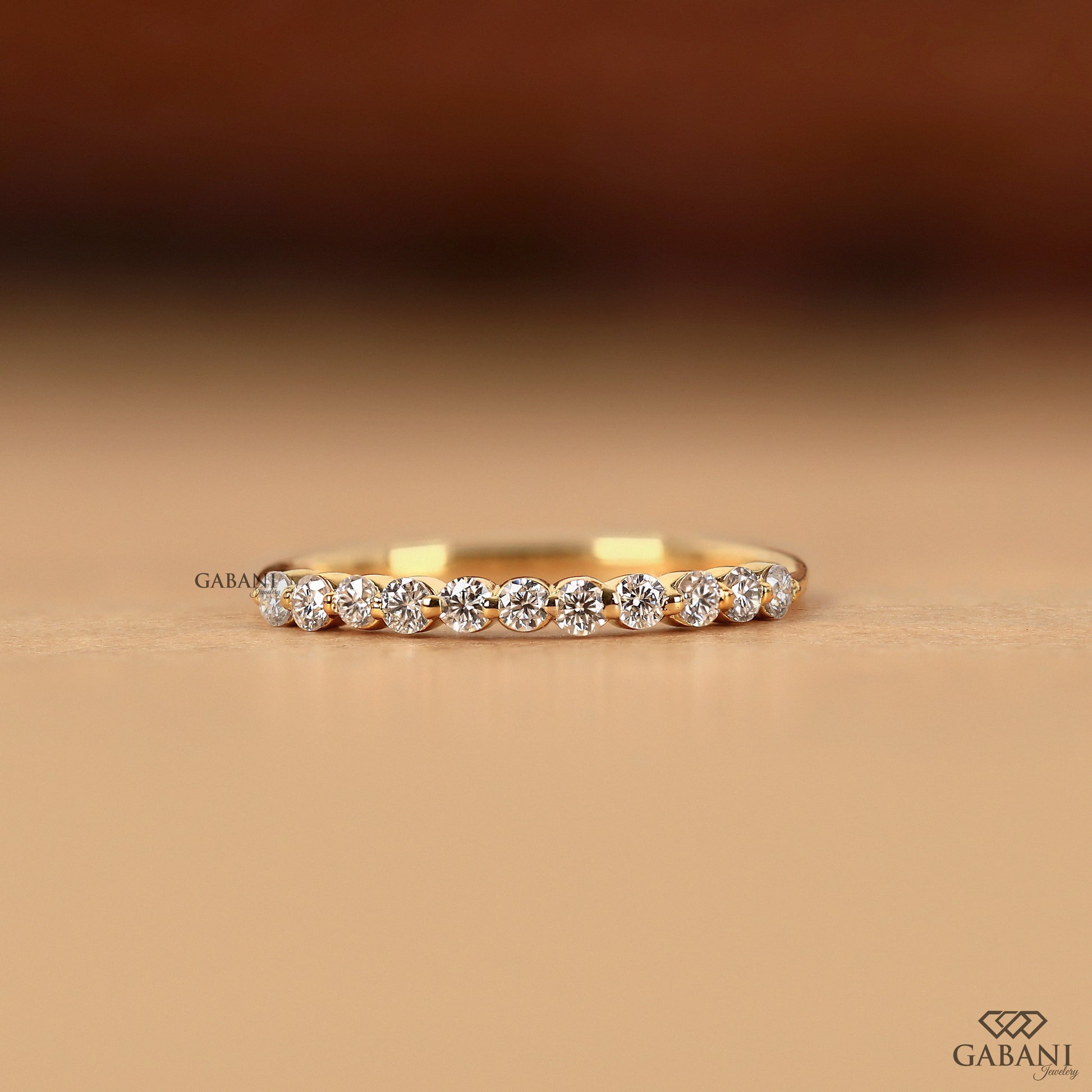 Round diamond wedding band in 14k gold with single prong setting