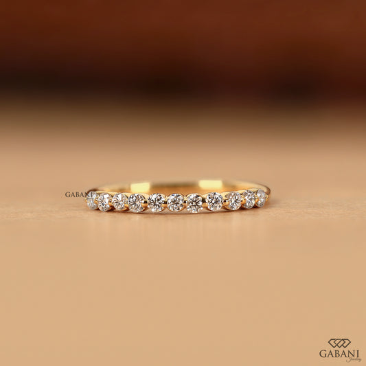 Round diamond wedding band in 14k gold with single prong setting