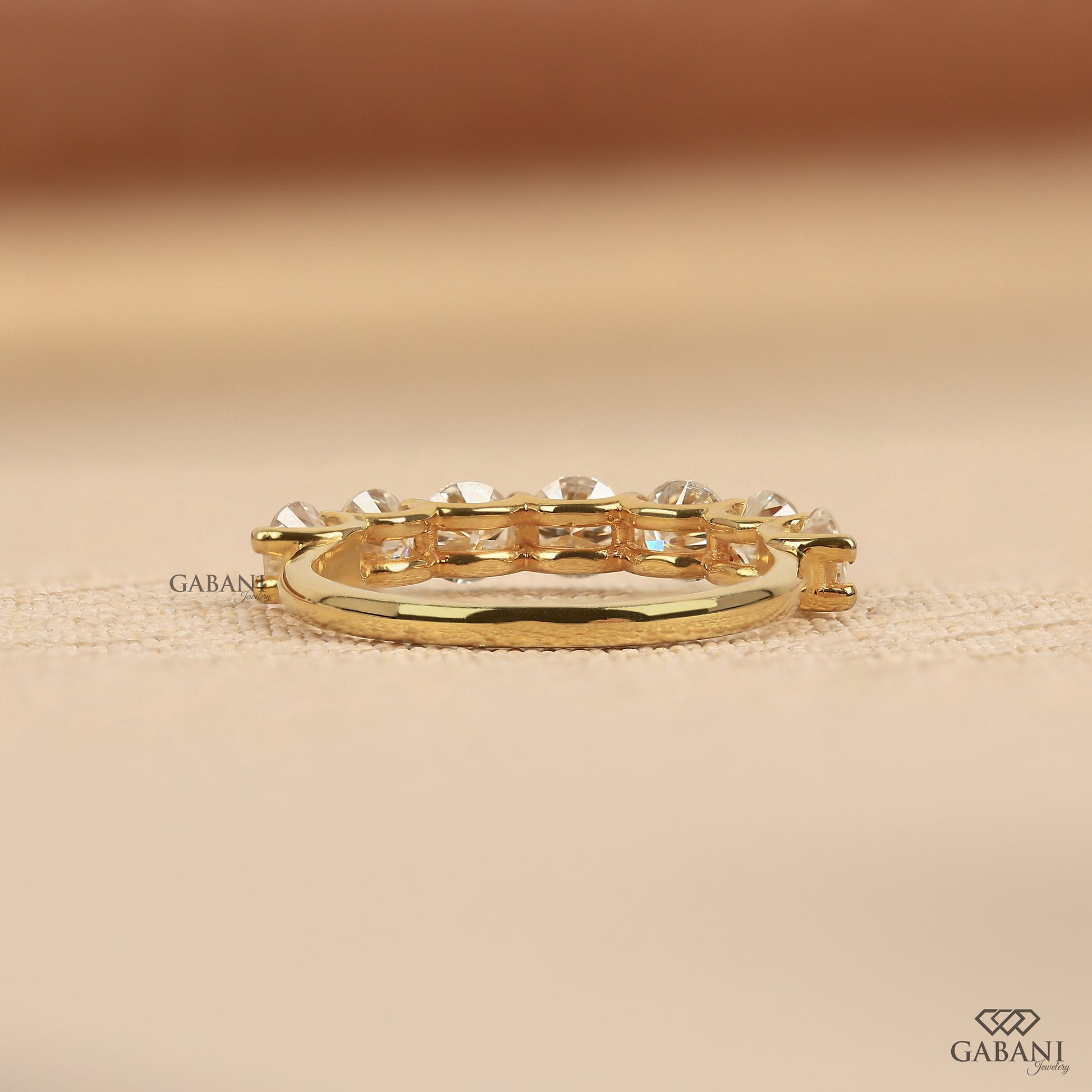yellow gold wedding band featuring seven round cut lab grown diamonds in a U prong setting