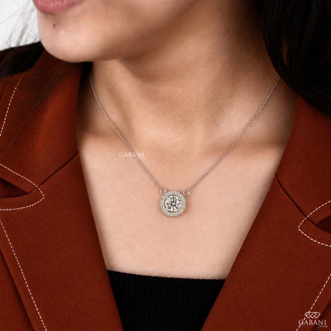 Round cut lab grown diamond floating halo pendant in white gold with a four prong center setting and circular pavé diamond halo.