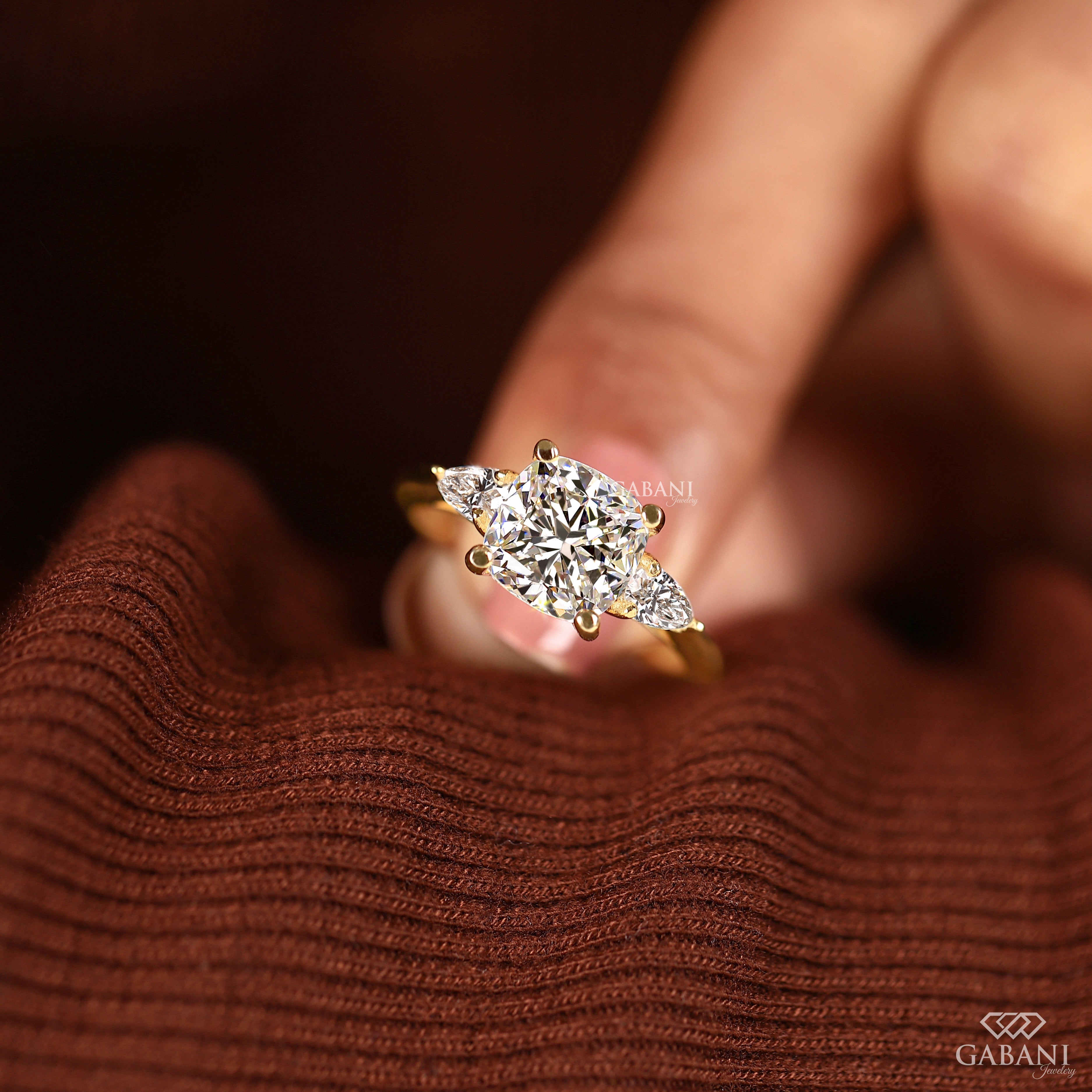 Three stone lab grown diamond ring with cushion cut center