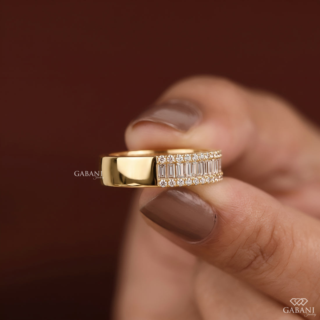 Side view of wide yellow gold lab grown diamond wedding band with baguette and round diamonds