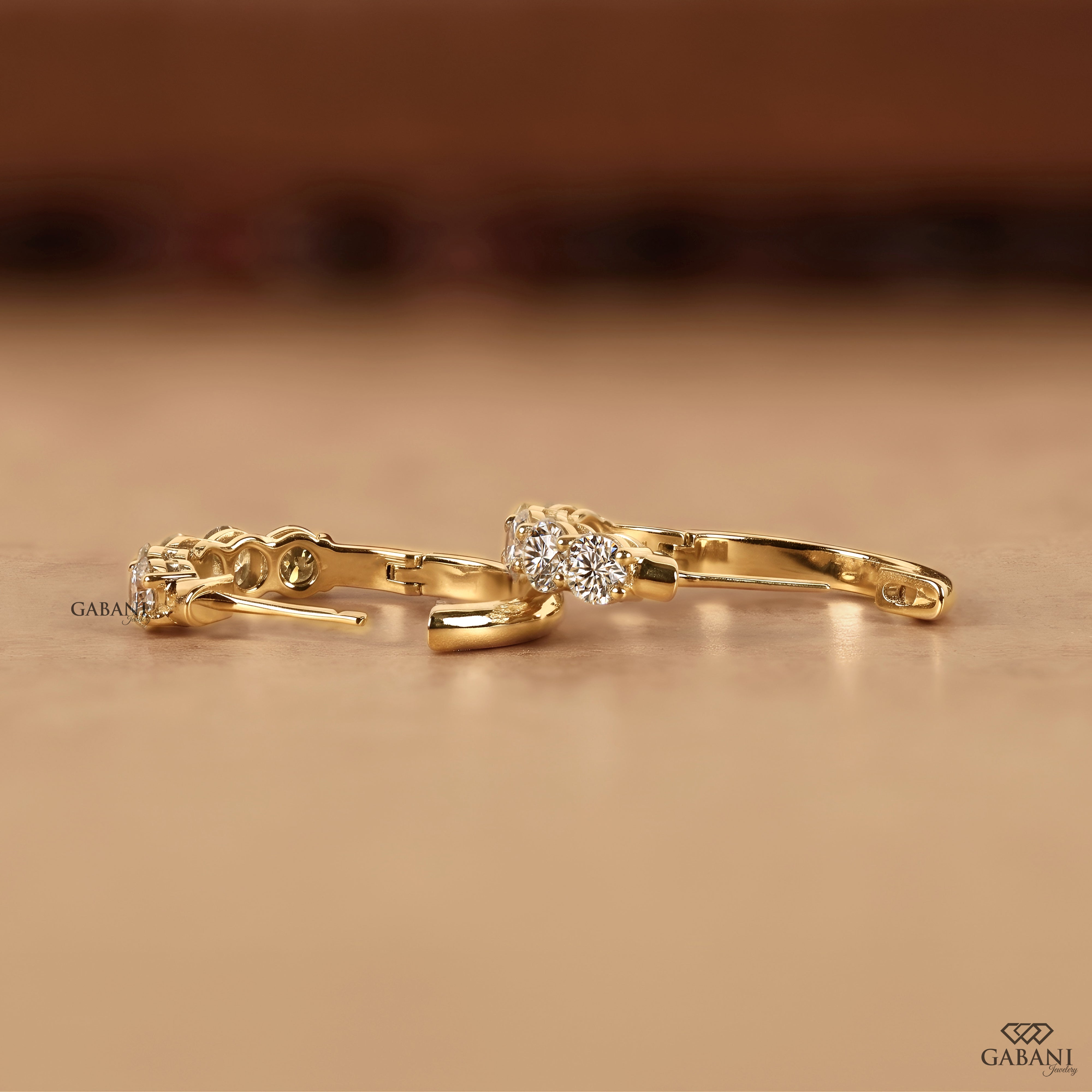 Round cut lab grown diamond earrings in a comfortable yellow gold hoop style