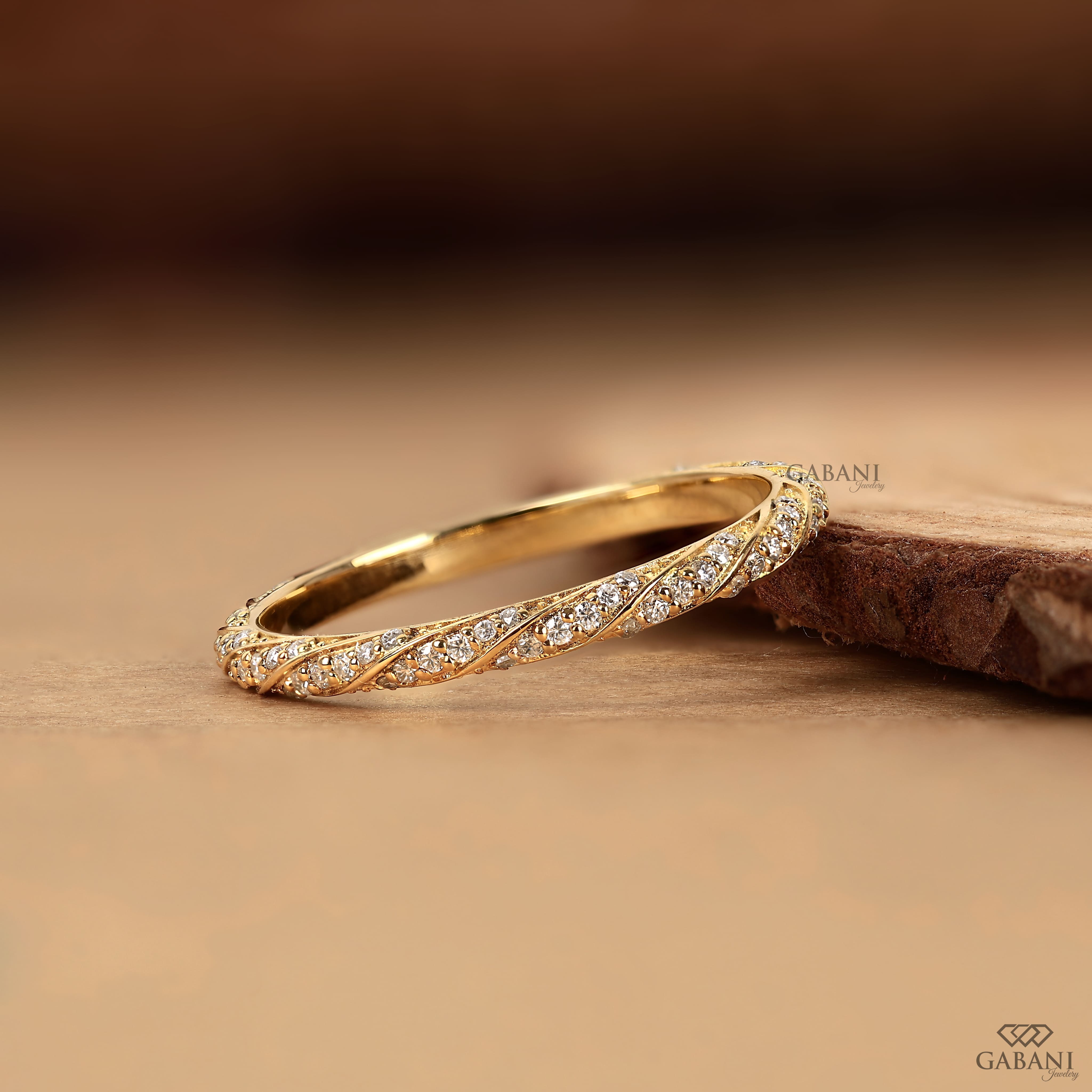 a vintage-inspired lab grown diamond wedding band featuring flowing yellow gold vine curves, round diamond accents and fine milgrain edges, ideal for bridal stacking and anniversaries.
