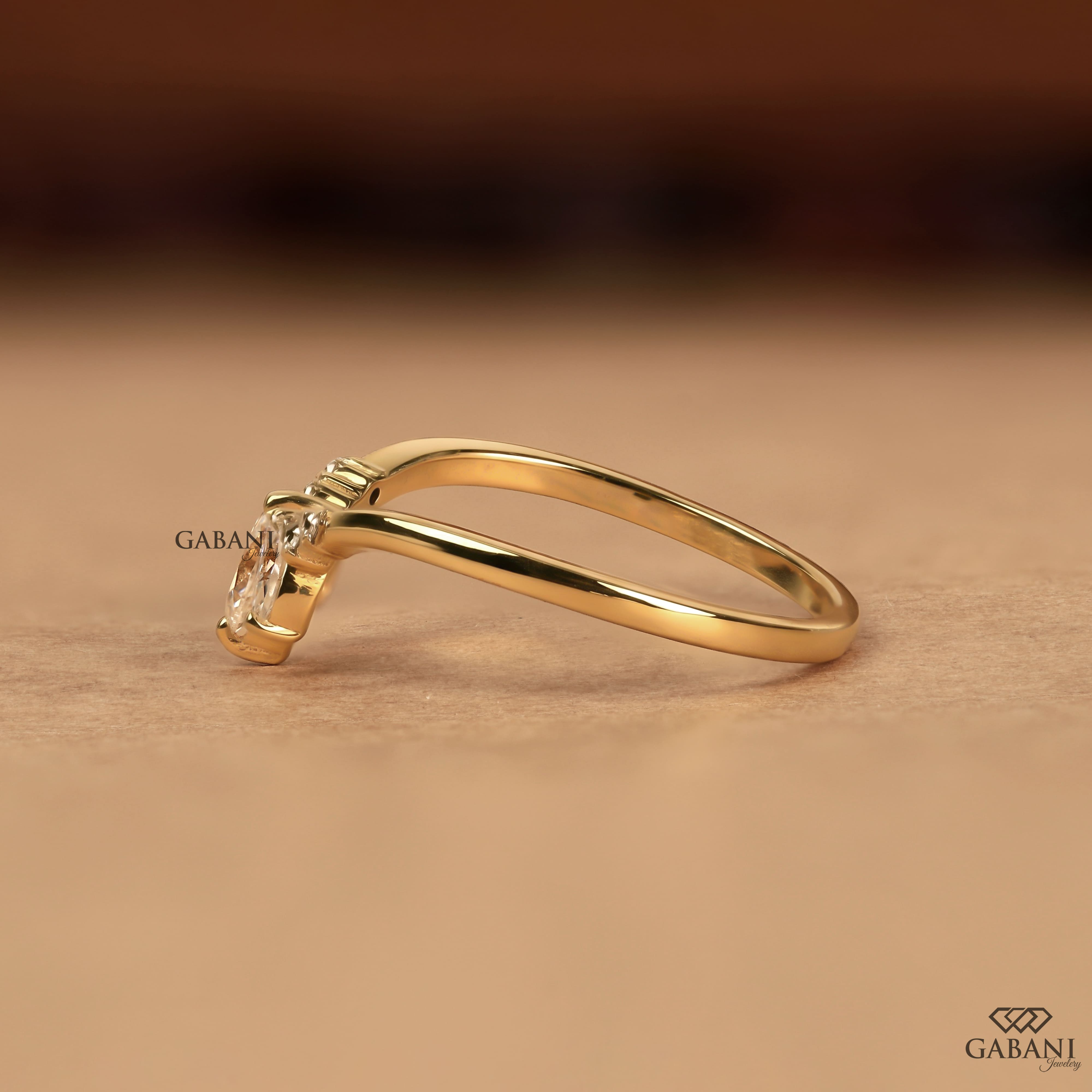 Marquise and round cut lab grown diamond curved wedding band in 14K yellow gold with a contour design, ideal for stacking with an engagement ring.
