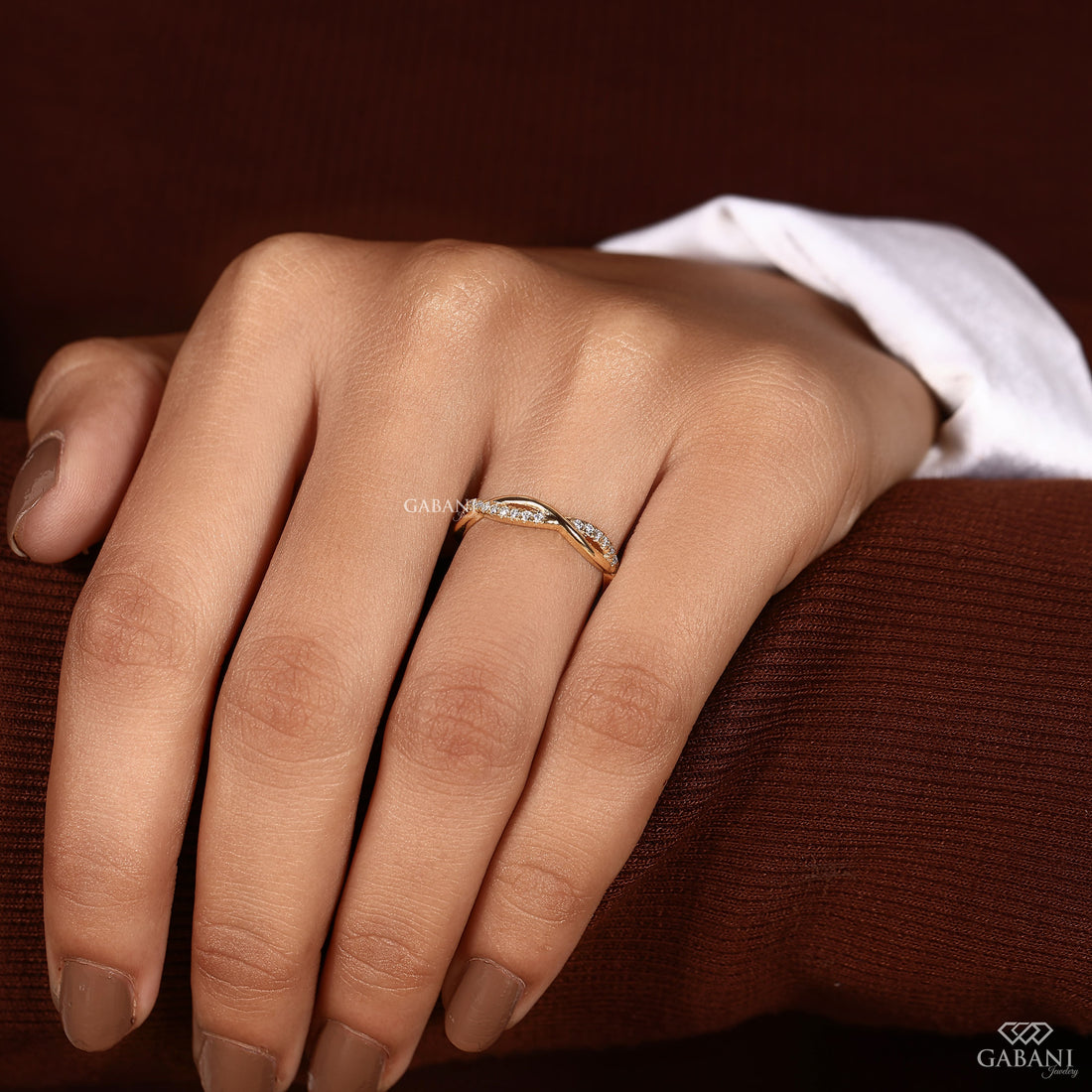 Twisted full eternity lab grown diamond band in yellow gold with round cut diamonds and an infinity inspired crossover design for wedding, anniversary, and stackable wear.