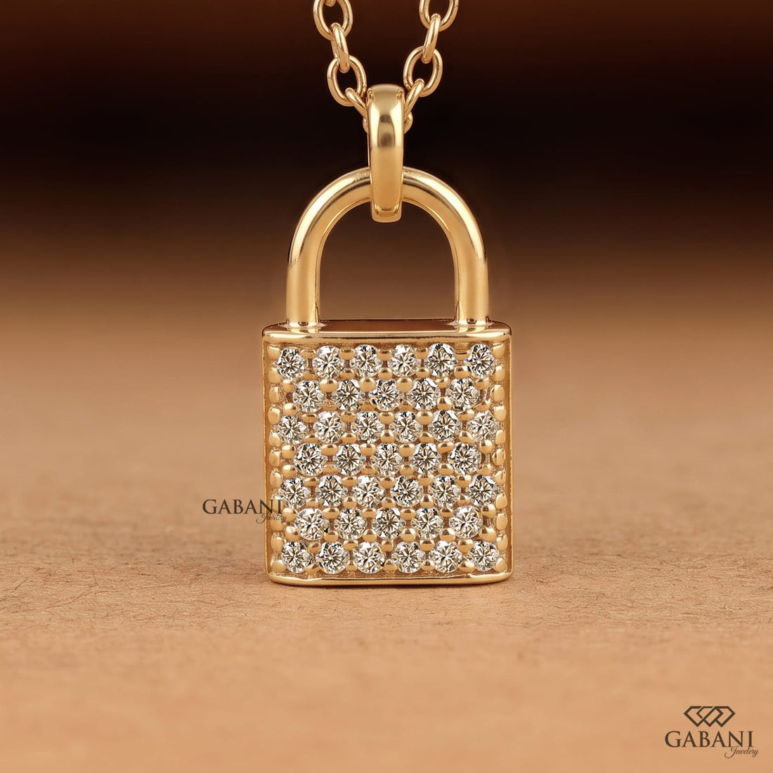 Yellow gold padlock pendant necklace featuring rows of round cut lab grown diamonds in a pavé setting with a polished gold shackle.