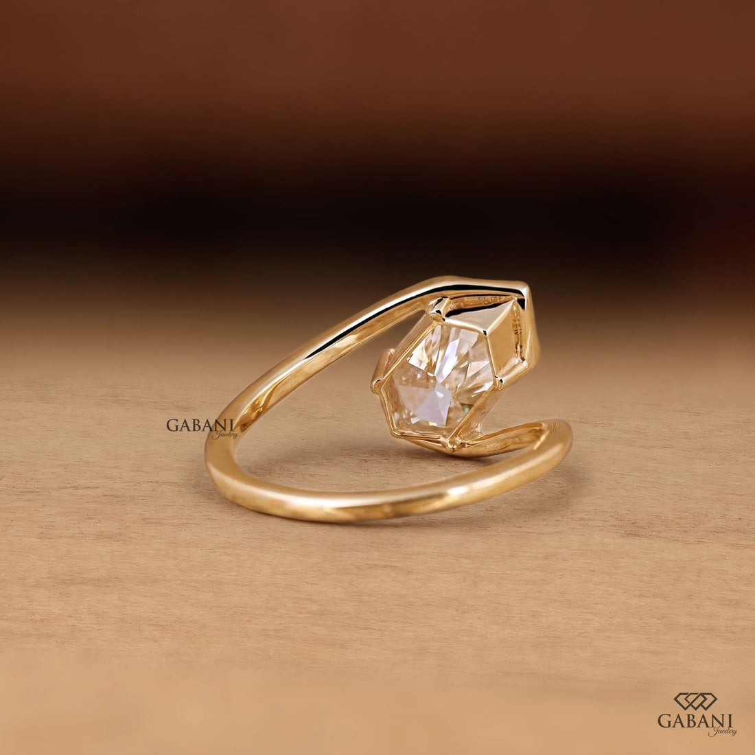 Marquise cut lab grown diamond engagement ring with prong setting, modern split shank design and polished yellow gold band.